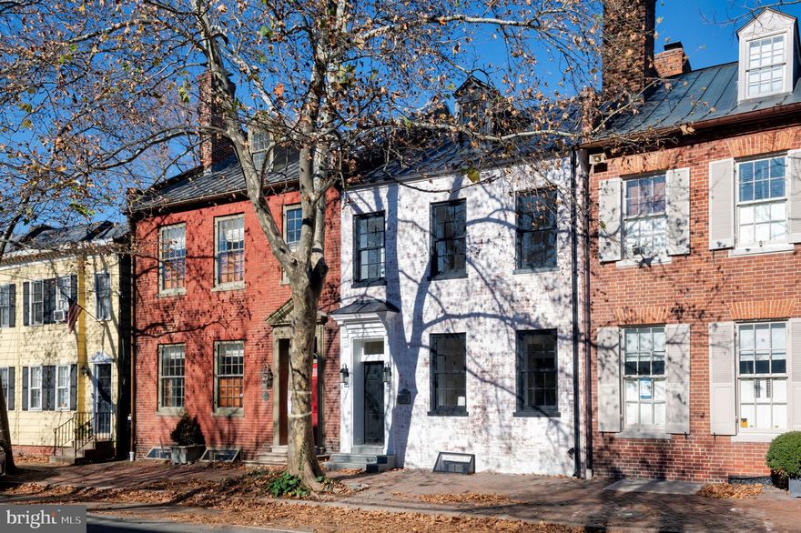 Welcome to your dream home in the heart of Historic Old Town Alexandria. Nestled just a few blocks away from the majestic Potomac River, this timeless residence offers a blend of historic charm and modern luxury. Experience the convenience of city living with schools, parks, renowned restaurants, and shopping all within a stone's throw. The exterior of this enchanting abode showcases the rich history of the area, boasting original brickwork dating back to 1816 when the home was first built.  As you step into the meticulously landscaped outdoor seating area, you'll be greeted by a haven of relaxation featuring flagstone pathways, elegant lighting, mature trees, and an oasis of privacy. The interior has been thoughtfully and fully remodeled, ensuring that every corner exudes comfort and sophistication. The heart of the home is the chef's kitchen, adorned with top-of-the-line Bosch appliances that promise culinary excellence. Quartz countertops, a wine fridge, a sprawling center island, and the subtle glow of under-cabinet lighting create an atmosphere perfect for entertaining or daily indulgence. Hardwood floors enhance the warm ambiance, while generous ceiling heights throughout the entire home provide an open and airy feel. A dedicated dining room with custom built-ins sits just off the stunning front family room with a historic fireplace dating back to the early 1800s. The upper level hosts three bedrooms, two full baths, and a conveniently located laundry area. The primary suite stands as a testament to bespoke design, featuring a custom accent wall, an exquisite luxury master bath, a walk-in closet, and an abundance of invigorating natural light. The 4th-floor loft can serve as an additional bedroom or is perfectly situated for a home office with a private half bath. Your lower level boasts a large rec room space with a dry bar, full bathroom, and brick accents from 200 years ago. Makes for a perfect wine cellar, kids room, or just a quiet place to relax after a long week of work. This remarkable residence captures the essence of Old Town Alexandria's historic allure while offering all the modern amenities discerning homeowners desire. Immerse yourself in a lifestyle where the past seamlessly meets the present, creating a space that you'll be proud to call home. Don't miss the opportunity to experience this captivating property firsthand—schedule a viewing today and step into a world of timeless elegance and contemporary comfort.