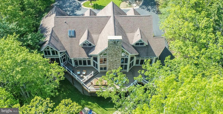 A spectacular Deep Creek Lake offering!  Here is your rare opportunity to experience the best in lake living at the Blakeslee, Deep Creek Lake's most complete development.    

Located on the desirable southwest portion of the lake, the level wooded lakefront lot faces directly across the lake to the yacht club and offers opportunities to view spectacular sailboat races.   from your private dock or shoreline.   

The 5/6 bedroom 5.5 bath retreat offers an open floor plan with expansive indoor and out door living spaces.   It all begins with an inviting great room facing the lake, includes a beautiful fireplace and a series of impressive open beams.   The completely remodeled kitchen provides the perfect layout for every meal and occasion.  Or, step out and enjoy the expansive deck, lean back in your screened porch or relax in the large family room.   The main level also includes a private bedroom suite, den, powder room and laundry.  

The second level features 3 guest suites, including a grand primary suite with sitting area, large walkin closet and a luxurious bath.  All of the suites have updated bathrooms and plenty of privacy.    A loft area overlooks the great room and offers plenty of natural lighting.  

If you head to the lower level, be ready because it is game on.  With a wide open activity area, bar, fireplace, room for game tables and plenty of seating areas,  it is perfect place to have a great time.  There is also direct access to the outside for corn hole and or other outdoor games.   There is a bedroom and an additional sleeping area/bonus room depending on your needs.   

When it comes to storage, the lower level offers plenty, including a "toy" garage, perfect for waverunners, ATV's etc.   There is also another mechanical/storage area that has plenty of space and even an opportunity for a wood shop.  

Blakeslee is known for spacious lots, great amenities, underground utilities and over 100 acres of dedicated common areas.  The amenities include an indoor community center with heated pool, tennis, basketball and pickleball courts, ball field, tot lot, storage areas for boats and trailers and a dedicated trash removal area.  

Lakefront homes in the Blakeslee are rarely offered and or available.  Especially ones that offer the features and benefits that this one does.   Schedule your private showing now.