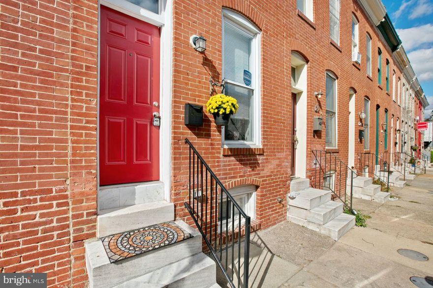 Gorgeous Townhome priced to move with open floor plan, hardwood floors, exposed brick, stainless appliances, second-story deck, WITH A PARKING PAD, and much more. Fully finished basement with bedroom and full bath. Plenty of closets and storage. Just 1 1/2 blocks from Patterson Park, one of the most vibrant green spaces in the city! Minutes from I-95, Hopkins, and downtown.