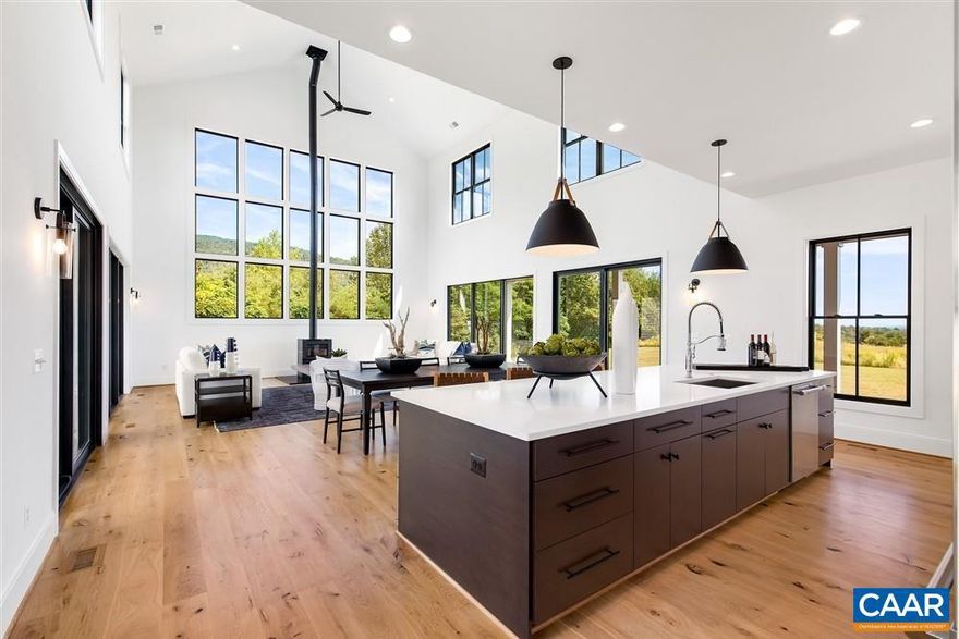 This home was tailor made for the amazing views this Western Albemarle location provides.  With over 1,700 SF of covered mahogany decking, you can take in both sunrise and sunset for either of the expansive covered porches.   The great room boasts 26' ceilings with a window wall that looks directly up at the intersection of Skyline Drive and the Blue Ridge Parkway atop Afton Mountain.  There is a modern open kitchen with professional grade appliances and an abjointing butler's pantry with microwave/speed oven.  The main house has two primary bedrooms (main floor and second).  The detached oversized 3 car garage has a separate living area above complete with 2 beds/ 2 baths, kitchenette and dedicated laundry.  Take advantage of one of the best lots in Stockton Creek now.  The builder needs the model for approximately 15 months on a leaseback.  The listing agent is part owner of the Builder/Seller.,Quartz Counter,Fireplace in Great Room