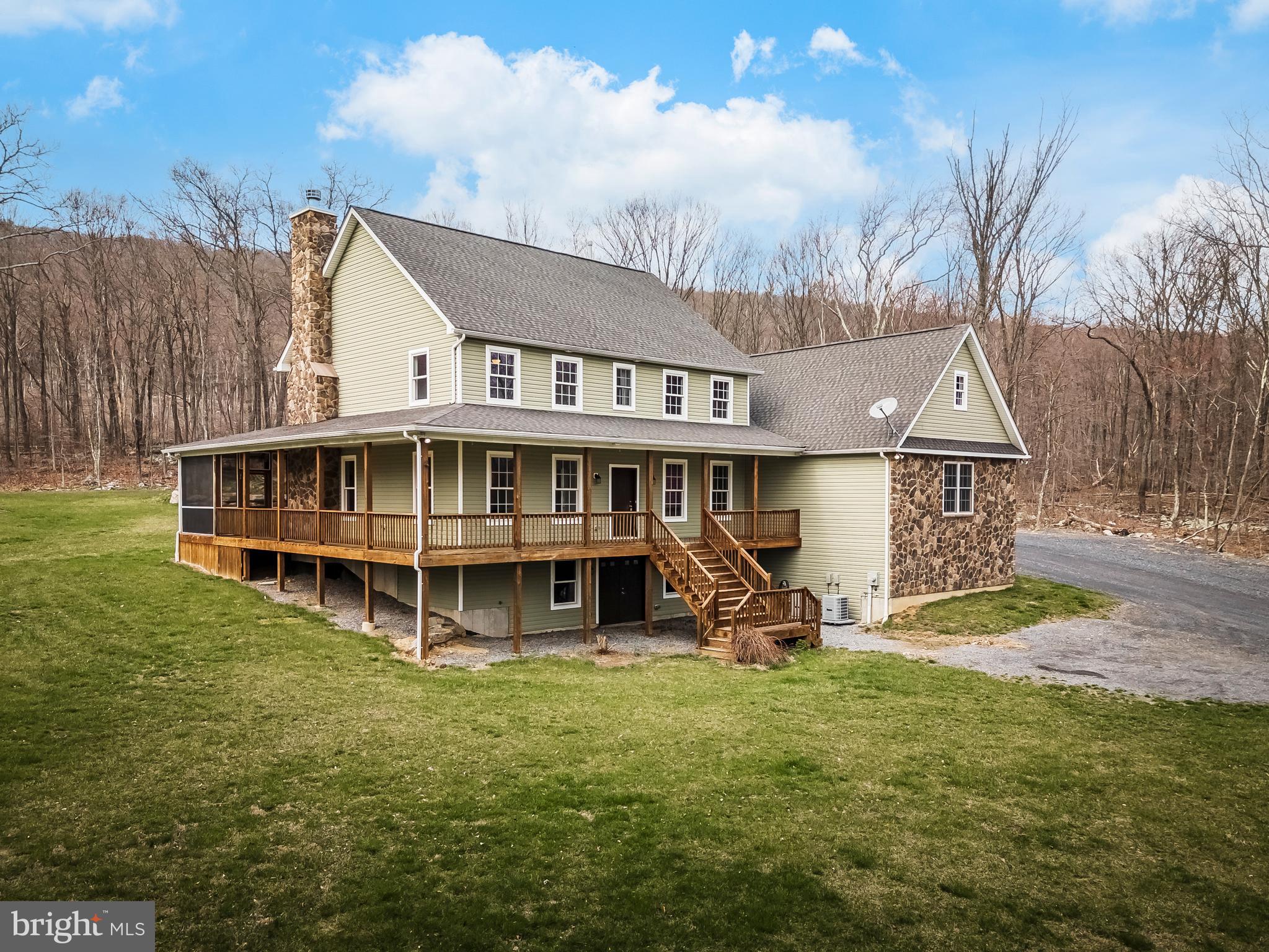 Tucked away on nearly 15 acres, this exquisitely built Nazareth SD home seamlessly blends classic luxury with modern updates. Thoughtfully designed, features include a gourmet kitchen with tile floor, stunning 18 foot ceilings, granite countertops, SS appliances, soft close drawers, pantry, gas cooking, double sink, ceramic tile backsplash, breakfast bar w/ seating for 4, chandelier & slider door leading to screened-in deck overlooking the backyard. Adjacent to the kitchen is the family room- with hardwood floor, ceiling fan and gorgeous wood-burning fireplace with stone hearth. The main floor master suite provides a generous walk-in-closet and full en suite with porcelain tile floor and backsplash, recessed lighting, granite double sink, private water closet, soaking tub, picture window and a glass enclosed shower w/ custom tile shelves. The lower level of this home is fully above grade and includes a stunning in-law suite with full eat-in kitchen, living room, bedroom with walk-in-closet and full bath with separate laundry from the rest of the residence- perfect for multi-generational living. Fresh paint and new carpets throughout ensure that every detail has been attended to. For convenience there is a 20 KW whole house generator that you can live off of for 2 months without power. With zoned heating & central AC, gas cooking in the main kitchen, ample space to relax, and the beautiful grounds of this exquisite property, there is nothing to do but move in!