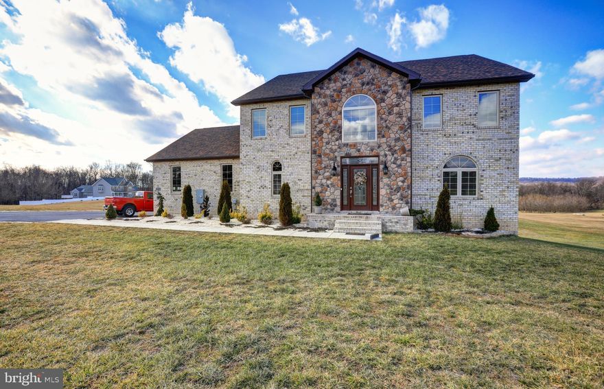 Located in the sought after gated community of  Crossings on the Potomac, this custom built Colonial offers 5000+ Sq. Ft. of finished living space resting on 6+ acres! This beautiful home has 4 Bedrooms and 4.5 Bath, 2 Pre-wired home theaters, high end finishes and molding, an insulated 3 car garage, Gourmet Kitchen with granite counter tops, custom cabinetry, stainless steel appliances, wall oven, built-in microwave, and large island. Fully finished lower level perfect for out of town guests or family staying and wanting their own space. Take in the seasonal mountain views from the rear deck or custom patio area with new hot tub! This community offers a marina area with deep water access on the river with boat docks and slips. Truly a MUST SEE!