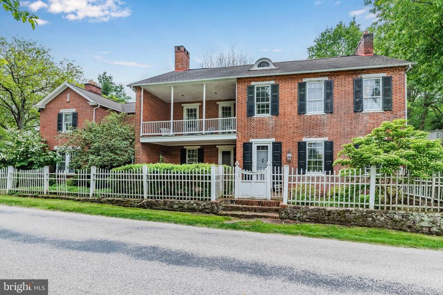 This picturesque retreat along sought-after McCormick Road features an 1830 farmhouse nestled on a stunning 5+ acre property fronting the tranquil Yellow Breeches. Surrounded by lush greenery and a sense of tranquility, the spacious home offers a perfect blend of rustic charm and modern comfort. 5,000+ square feet. From the road you are greeted by a white picket fence that encloses the beautifully landscaped front yard and English gardens. The house itself features a classic design with a blend of brick and wood siding, exuding timeless appeal. Stepping through the front door, you enter a foyer adorned with hardwood floors and streaming natural light. The open floor plan seamlessly connects the main living areas, creating a sense of flow and openness. The living room, with its high ceilings and large windows, provides a bright and inviting space, perfect for entertaining guests or simply relaxing by the fireplace on a chilly evening. First floor in-law suite with full bath and private entrance. 2nd floor owner suite with updated private bath. 4 additional bedrooms and 3 full baths. 3rd floor is complete with 2 spacious rooms and an additional full bath. The original summer kitchen makes the perfect hangout or office space. 2 car detached garage includes lower-level pool house with full bath. Original hardwood floors, balcony, in ground pool, tennis court, 4 fireplaces, large brick patio, covered porch all overlooking the creek. Fabulous price allows you to make this home your own with some TLC. Rare opportunity to own a piece of history along the Yellow Breeches.