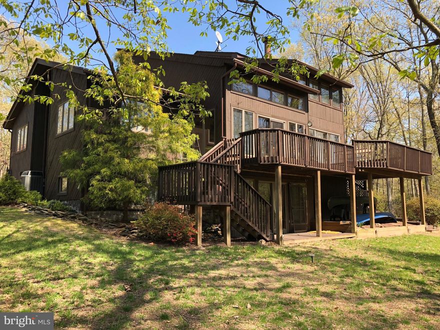 European inspired custom built cedar & stone contemporary on 27 acres. Entertainers dream w\2 level decking,screened in porch,volleyball/horseshoe & outdoor fire pit. Extensively renovated&updated from top to bottom. Stacked stone fireplace,luxurious master bath&beautiful open kitchen with 3 ovens. Hickory hardwood on the main level. Radiant floor heat on all levels & dual zone HVAC.  Roof 2015