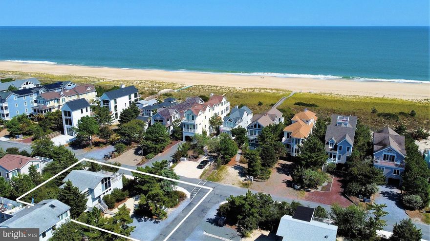 Just one-off the oceanfront, this classic beach cottage is positioned on a large lot in a private gated North Bethany community with lifeguards. This beautiful beach retreat is full of coastal charm and features a wide open great room with wood beamed ceiling, gas fireplace, and floor to ceiling windows which allow for ample natural lighting. There is a spacious deck just off the great room where you can enjoy peeks of the ocean while listening to the waves crash on the shore. Downstairs there are 4 sizeable bedrooms and 2 full bathrooms, each updated with tile showers, new vanities, and tile flooring. Enjoy this home as is or build your dream beach home and take advantage of incredible views of the ocean from a higher vantage point in this coveted location.  The private, gated community of Ocean Village has been recognized for their exceptionally wide dune and beaches. Positioned on a corner lot adjacent to the dune crossover, this home is just steps to the beach and a short walk to downtown Bethany, making this is the perfect location for all of your future vacations.