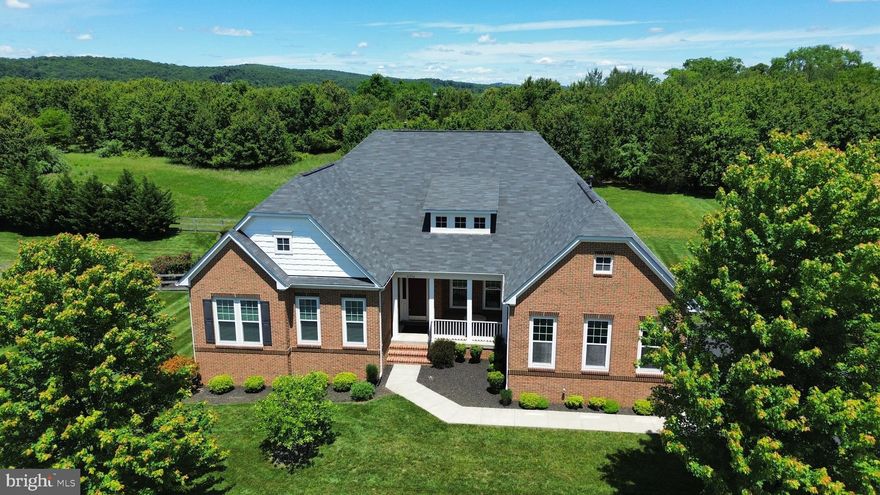 Open House Both Saturday and Sunday - 12-2PM!  True main-level living awaits in gorgeous golf course community of Raspberry Falls!  Rarely available Northridge model offers over 5,600 square feet of finished living space, and is a masterpiece of main-level living with a main-level primary suite featuring 12' ceiling heights!   Designed for seamless entertaining, the open floor plan centers around a chef’s kitchen, equipped with abundant cabinet storage, expansive countertops, a large center island, and a sunlit morning room extension that offers views of the private backyard. The spacious family room is a true retreat, featuring a cozy gas fireplace, elegant crown molding, and a dramatic tray ceiling soaring 12'!

The spacious main-level primary suite is an oasis of comfort, complete with two generously sized walk-in closets and an opulent en-suite bath featuring separate vanities, a large garden soaking tub, an oversized shower, and an enclosed water closet. 

Two additional well-appointed bedrooms on the main level each offer walk-in closets and share a beautifully designed second full bath, complete with a double-sink vanity and a separate enclosed shower and water closet.

The finished lower level is a showcase of versatility, offering an expansive recreation area perfect for entertaining, a dedicated space for gaming tables, a home theater viewing area, and a full wet bar. This level also includes a true fourth and fifth bedroom, ideal for guests, a home gym, or a hobby room, along with a third full bath featuring a double vanity and enclosed water closet and tub. Ample unfinished storage space provides exceptional organization potential.

Step outside to a private deck overlooking a serene backyard, backing to open space and mature trees—offering unparalleled tranquility and privacy, all tucked away in a quiet cul-de-sac.

Welcome to Raspberry Falls Golf and Hunt Club - an exclusive community featuring one of Gary Player’s signature golf course designs!  Nestled just 10 minutes from the heart of historic downtown Leesburg - renowned for its vibrant restaurant and brewery scene - this prime location offers unparalleled convenience. Positioned at the gateway to western Loudoun County, it provides easy access to a collection of award-winning wineries and breweries, making it a true haven for both relaxation and entertainment.