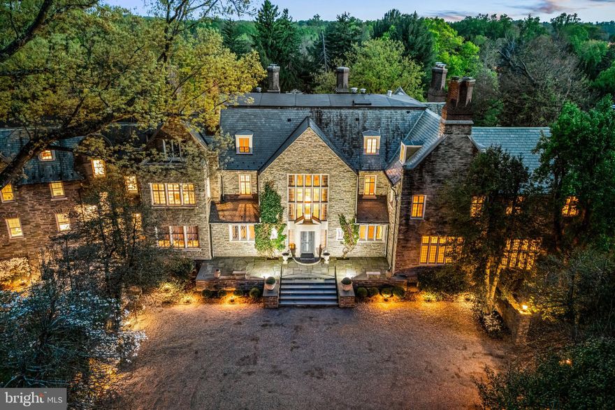 Welcome to iconic Ravenscliff, one of the most significant historic estates ever constructed along the Main Line in 1904, for railroad entrepreneur Willam T. Wright. It was then gifted to William's son, Willam Cox Wright upon his marriage to Campbell Soup heiress Charlotte Dorrence in 1934, who lived there until its most recent owners purchased it in 1979. Set on over 9 breathtaking acres at the top of a private hill with glorious vistas, this sun-filled, beautifully renovated country English-style residence impeccably blends extraordinary architectural designs, masterfully crafted plaster moldings accentuating the 18-30 foot first floor ceilings, rich mahogany paneling, massive floor to ceiling windows, perfectly restored original floors and hand carved millwork with the finest modern amenities, exquisite fixtures and curated refinements throughout. Every detail has been carefully thought through to create a stately, gracious family property that lends itself easily to inviting every day family living spaces with a spectacular open flow for intimate or large-scale entertaining events year-round. Endless features include the spectacular front to back entrance foyer with fireplace, soaring ceilings, marble floor and walls, incredible plaster moldings and views of the stunning gardens and grounds, comfortable library with beautiful mahogany paneling, built-ins, fireplace and hand carved doors, bright great room (ballroom) with two fireplaces, perfectly restored oak floors and two walls of windows and French doors leasing both outside and into the wonderful Florida room offering floor to ceiling windows and French doors, marble floor and built-ins designed for entertaining, two powder rooms with generous vestibule areas, cozy second office with oak floors and custom built-ins, a  grand dining room with fireplace, rich, hand carved paneling and moldings, fabulous oak floors and large windows overlooking the terraces, gardens and expansive lawn, adjacent butler's pantry and white kitchen, both designed by Joanne Hudson, with 6-burner Gaggenau cooktop, double Meile ovens, 48" SubZero refrigerator, 36" SubZero freezer, multiple beverage drawers, wine refrigerator 3 dishwashers and a wine refrigerator, convenient desk area, second catering kitchen space leading to a screened in porch, a stunning breakfast room in addition to the eat-in table spaces within the kitchen and an open flow into the comfortable family room. Ascend the dramatic main staircase with massive stained-glass window overlooking the front courtyard to the second floor or use the 4-stop elevator which provides easy access to each of the 4 flat floors within the residence. The second level offers a luxurious primary suite with fabulous barrel vaulted bedroom with fireplace, sitting room, his and hers bathrooms, dressing room, 4 walk in cedar closets with additional custom cabinetry for shoes and accessories, 3 additional bedrooms with en-suite baths, a morning room, second floor laundry and storage and a space for a potential in-law suite with full kitchen, proximate full bathroom and plentiful California closet spaces. The third level features a large bonus/ playroom, hall bathroom, 2 bedroom suites with en-suite baths, an exercise room, potential office space and more. Step outside from multiple rear exits of the incredible home for easy access to terraces, spectacular plantings, expansive lawns and landscape designs, the beautiful pool, complimented by the pool house which offers outdoor cooking capability, refrigeration, changing space and a bathroom, oversized 4-car garage, courtyard parking spaces and more. This is a once in a time opportunity to own an incredible piece of history which has been restored and perfectly enhanced for its next lucky stewards, offering complete privacy while being within minutes of renowned public and private schools, endless clubs and recreational facilities, world class dining and shopping and all forms of transportation.