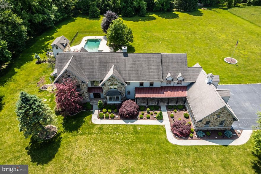 A peaceful tree lined driveway welcomes you to Deer Meadow.  This expansive property situated on a 4.90 acre parcel subdivided from one of the oldest farms in Chester County dating back to the late 1700's. This Ann Capron designed custom built Chester County farmhouse is thoughtfully designed high quality construction for enjoying life at its finest.  The center hall Foyer with gleaming red oak flooring has arched  entries to the elegant Living Room on one side with a formal Dining Room on the other both with custom millwork.  A handsome turned staircase invites you to the upper level.  There is a large Study with attractive  built-ins and outside entry to a secluded deck.   An antique door from the late 1800's provides access to the lower level.  Step down to the spacious Family Room with a handsome double sided stone gas fireplace and French door access to a fabulous covered outdoor Porch .  The heart of every home, an expansive Kitchen with a Breakfast Bar that seats 12 plus and  Breakfast Room with an antique mantel that is a repurposed barn beam gifted from a Dupont farm.   There is a wall of windows that overlooks the lush tree lined backyard and continues into the sunny Florida Room.   A Butler Pantry with a pocket door  leads from the Dining Room to the Kitchen .   Enter from the oversize 3 car garage  to a Mudroom and hallway with two doors to the outside  plus back stairs to upper and lower levels.  Walk in pantry and Powder Room complete the main floor.  The upper level features a Primary Suite with a Sitting Room,  secluded balcony, large walk in closet with built-ins, and the en-suite Bath with vaulted ceiling, double bowl vanity, water closet, soaking tub and walk in shower.  Five additional generous bedrooms each with private access to three Full Bathrooms, a Laundry Room and massive floored walk-in attic for easy storage are found on the second floor.  The well conceived floorplan continues  in the lower level with handsome tigerwood floors.  A large gathering area, with a separate Exercise Room,  perfect spot for a bar with hand blown Italian glass shades and a Game Room.  Step down to the Billiard Room and there is also an office/hobby room.  Tucked into it's own area is ideal space for an In-law or au paire suite with a Den, Bedroom and full Bath including stairs to the main level.  Outside enjoy the private level lot that offers a stunning  built-in heated pool complete with a fabulous guest pool house that features a Den and full Bath on the first floor plus a Bedroom in the second floor loft.  This estate home is located in bucolic East Bradford Township and award winning West Chester school district.  Convenient to Philadelphia, Wilmington and New York with major highways, train and airport nearby.  BRAND NEW Hardie Board siding on the exterior and a freshly painted interior waiting for a new family to make unforgettable memories.