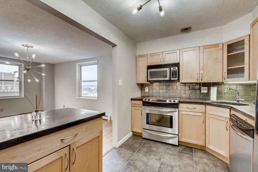 Contemporary renovation of upper level corner unit with three sides of windows located in historic Arts and Cultural district of Historic Mount Vernon. Full service secure elevator building with 24-hour desk and parking attendant located close to Penn Station, dining, nightlife, and harbor attractions.  Deli and convenience store on-site.  Parking in attached underground garage available for additional $150/mo. Hardwood floors throughout. NO carpet.  Concrete countertops and stainless appliances accent the modern kitchen. Black slate bath has glass shower enclosure. Kohler purist line of plumbing fixtures adorn the master bath.  New HVAC equipment in 2019.  Freshly painted with designer colors and upgraded solid hardwood doors and frames.  Every closet outfitted with custom organizers. Superb corner layout with views to North, South and West, overlooking the beautiful city skyline and remarkable architectural details of significant nearby buildings. This unit has wow factor, location AND views!  Please note that redesign of common area lobby and hallways in planning stages right now.   This floorplan provides multiple ideal locations for seamless installation of in-unit laundry!