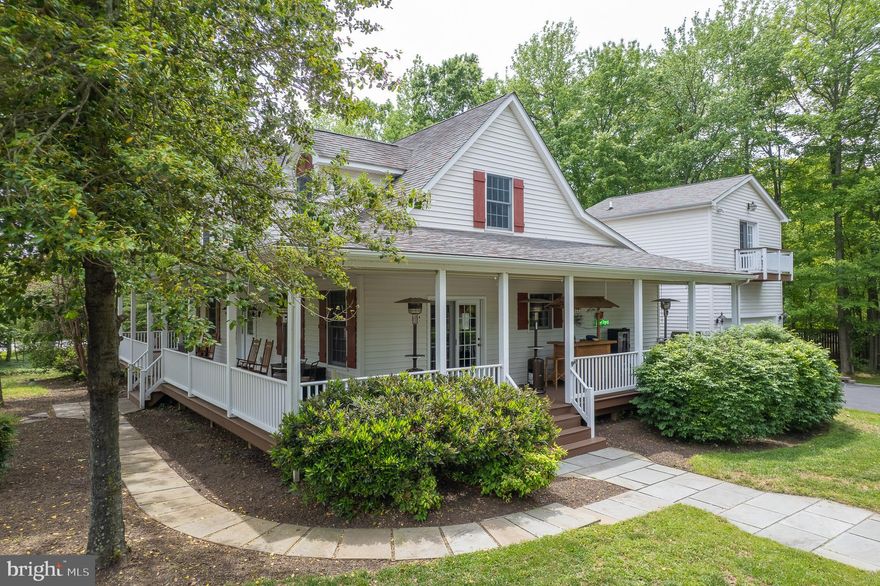 This beautifully maintained home offers timeless charm and modern comfort on a spacious 0.5+ acre corner lot with no HOA fees or restrictions.  Multiple MARINA's within walking distance; two have pools! This home features a stunning wrap-around porch providing ample space for entertaining—perfect for hosting up to 90 guests and a classic Maryland crab feast.  Hottbub off the back deck conveys too!  Inside, the main-level owner's suite features new carpet, walk-in closets, custom built-ins, and a large en-suite bath with a corner jacuzzi tub. The home showcases random-width yellow pine flooring, with new carpet in the owner’s suite and upper bedrooms.  Upstairs, you’ll find generously sized bedrooms with dormer windows and a large shared bathroom.  A finished loft above the attached garage—accessible via both interior and separate exterior entrances—could be 4th bedroom and includes a rough-in for a future bath. The kitchen is outfitted with GE and GE Café appliances, a gas range, and opens to the warm and inviting living space with a cozy propane fireplace.  Mechanical highlights include a 50-year architectural shingle roof, Carrier 2-zone heat pump with humidifier (2018), upgraded water conditioning system, and hot water heater replaced in 2020, 2x6 construction and Anderson Windows.  This is a rare opportunity to own a character-filled home with thoughtful upgrades, flexible living space, and plenty of room to entertain both indoors and out.  Plenty of paved, off-street and on-street parking for all your guests!