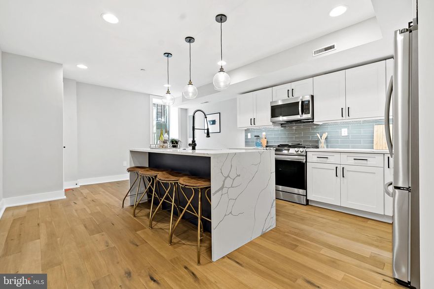 Welcome to Passyunk Place, beautiful new construction  development in the heart of Passyunk Square. These bi-level units offer an open floor plan filled with lots of natural light. Step inside to find wide plank hardwood floors, quartz countertops, white cabinets, and recess lighting, a built-in camera system with doorbell, and most importantly a 10-year Tax Abatement.

The main level features a front bedroom with closet space that also makes a great home office, along with a full bathroom, coat closet, and stackable washer and dryer. Toward the back of the home, you’ll find a spacious second bedroom with an ensuite bath located just steps from the rear door that leads out to the backyard. The lower level includes the kitchen as well as a half bath, storage, and a spacious living room. 

Located in a highly walkable neighborhood, you’re just steps from award winning  restaurants, cafés, and shops. A nearby playground, basketball courts, and open field add even more to love about this fantastic location.