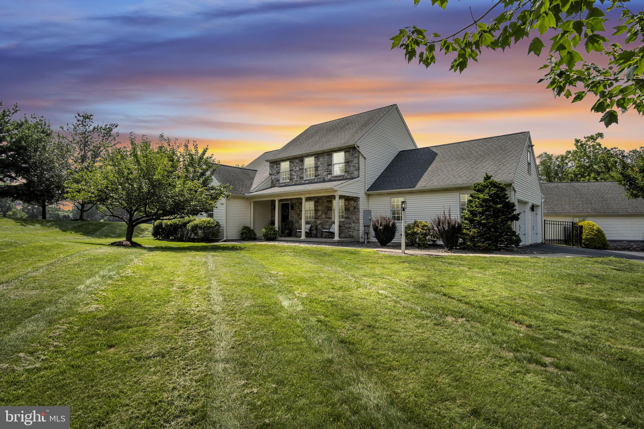 Come home to your own private retreat with peaceful, quiet surroundings and modern comfort throughout. This one-of-a-kind property is nestled on 17.5 acres of rolling hills and scenic beauty, zoned agricultural, offering the perfect blend of country charm and upgraded luxury.
Custom-built by Shaeffer and Son, this quality 1.5-story home spans 3,522 sq ft and features 3 bedrooms, 2 full bathrooms, and 2 half baths. The entire interior has been thoughtfully and extensively renovated from top to bottom. Step inside to find brand-new luxury vinyl plank flooring throughout both levels, freshly painted walls and ceilings, and an open, inviting layout perfect for family living and entertaining alike.
The brand-new kitchen is a showstopper—completely redesigned with white shaker cabinetry, oversized 42” uppers, white quartz countertops with gray veining, large black hardware, all new stainless steel appliances, and a gas range conversion for the serious home chef. A large island with a built-in microwave drawer in sleek black adds a functional and stylish centerpiece.
All bathrooms have been fully renovated, including new vanities, flooring, toilets, and fixtures. The master bathroom now features a modern dual-sink vanity, new tiled shower, updated floors, and tasteful finishes throughout. Accent walls in each bedroom add warmth and character, while updated half baths bring continuity and charm.
You’ll love the cozy country feel of the main floor with a two-sided gas fireplace connecting the kitchen and family room. The great room is light-filled and airy with its pine cathedral ceiling and southern exposure. Step down into the game room, highlighted by a stunning two-story flagstone gas fireplace, wooden beams, and bar—perfect for hosting guests or relaxing fireside.
The second level offers a spacious loft, two bedrooms, a full bathroom, and a bonus room tucked off one of the bedrooms—ideal for a private office, playroom, or studio.
Step outside to tranquil outdoor living at its best with a large covered patio, pergola, and inground saltwater heated pool, surrounded by expansive views and spectacular sunsets. Whether you're relaxing in the shade or soaking in the sun, this property feels like a private resort.
The detached carriage house/in-law quarters is a charming one-bedroom cottage with a fully re-painted interior*not pictured*, full kitchen, bathroom, living area, and laundry—perfect for guests, extended family, or rental potential. A separate detached 2-car garage includes a storage room and covered patio for recreational gear or workshop use.
Though it feels a world away, you're just minutes from Hershey Medical Center, Rt 283, Rt 322, and the PA Turnpike, as well as shopping, dining, and local attractions.
This beautifully upgraded and lovingly maintained property is more than a home—it’s a lifestyle. Come experience everything it has to offer.
