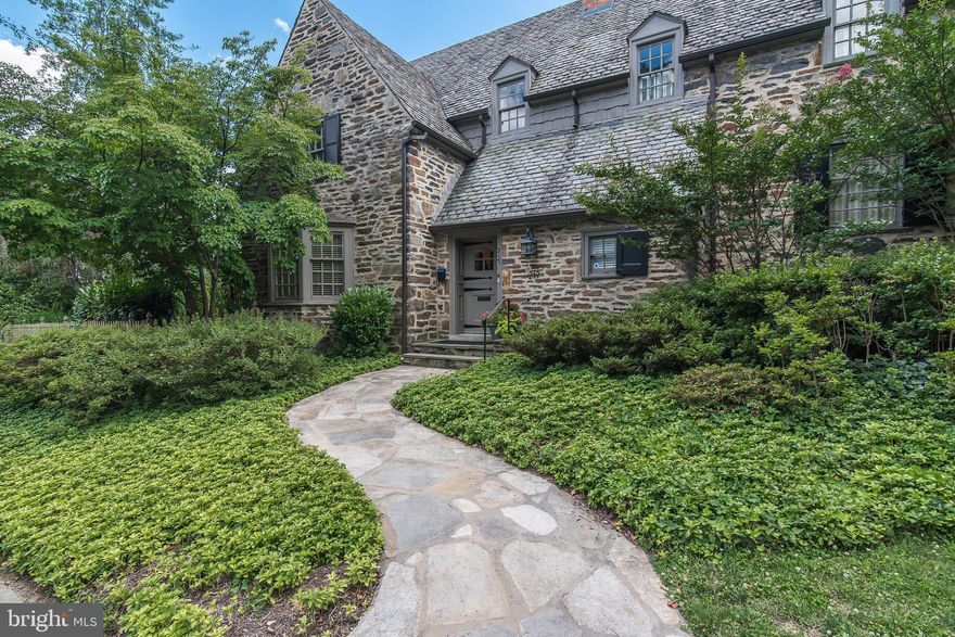 This dramatic signature stone Palmer Lamdin-designed home is considered one of the loveliest houses in Homeland. As stunning as it is on the outside, it is equally captivating on the inside. From the detailed millwork to the crown molding to the old world details, this is a show stopper! The layout is a perfect blend of traditional and unique spaces. The updated eat-in kitchen with large center island opens to a lovely family room with a bay window and floor-to-ceiling built-in shelves. the large living room has a stunning stone fireplace and french doors that open to a stone patio. The dining room is spectacular with its exposed stone walls, custom millwork and enchanting windows and doors. The master bedroom and bathroom are awash in natural light. Three more bedrooms and two full bathrooms, complete the magnificent living space. The upstairs  glamorous closet  and laundry room make it easy to store anything and everything. The outside living space will stop any professional event planner in her/his tracks. Two large blue- stone patios with gardens to the south and east are worthy of the cover photo for Home & Garden. From the extensive landscaping with mature trees and shrubs to the multiple flower beds - all nestled in two distinct and completely private settings. From the upgraded systems to the exterior improvements, this home will please the most discriminating buyer. It is Homeland's perfect home.