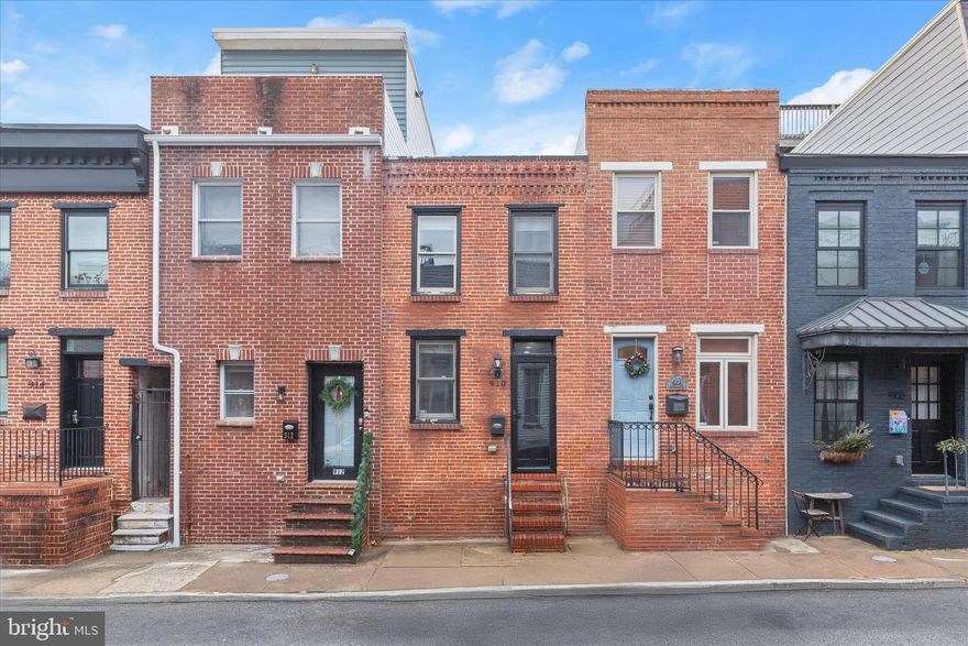 Welcome to 910 S. Decker Avenue, a beautifully updated 2-bedroom, 2.5-bath rowhome ideally located in the heart of vibrant Canton, just moments from top restaurants, shops, and the waterfront, and major commuter routes. Step inside to a sun-filled main level featuring an open floor plan with hardwood floors, crown molding, and a neutral color palette. The living area opens to an eat-in kitchen with stainless steel appliances, granite countertops, and tiled backsplash. A private fenced rear patio sits just off the kitchen and provides functional outdoor space. A powder room completes the main level. 
Upstairs, the primary bedroom boasts tray ceilings and a private en suite bath with walk-in shower. The second bedroom offers direct access to a tiered rooftop deck with city views. This outdoor retreat showcases sweeping city skyline views and is perfect for relaxing evenings or fireworks watching. An upper-level laundry area and an updated hall bath complete the second floor. 
Updates include a new roof (2022) and water heater (2021). Ample on-street parking available. 
Located just moments from The Shops at Canton Crossing, popular restaurants and pubs, Canton Waterfront Park, and major commuter routes including I-95, I-895, and the Charm City Circulator, this home offers the ideal blend of location, comfort, and city living.  

Select interior photos have been virtually staged.