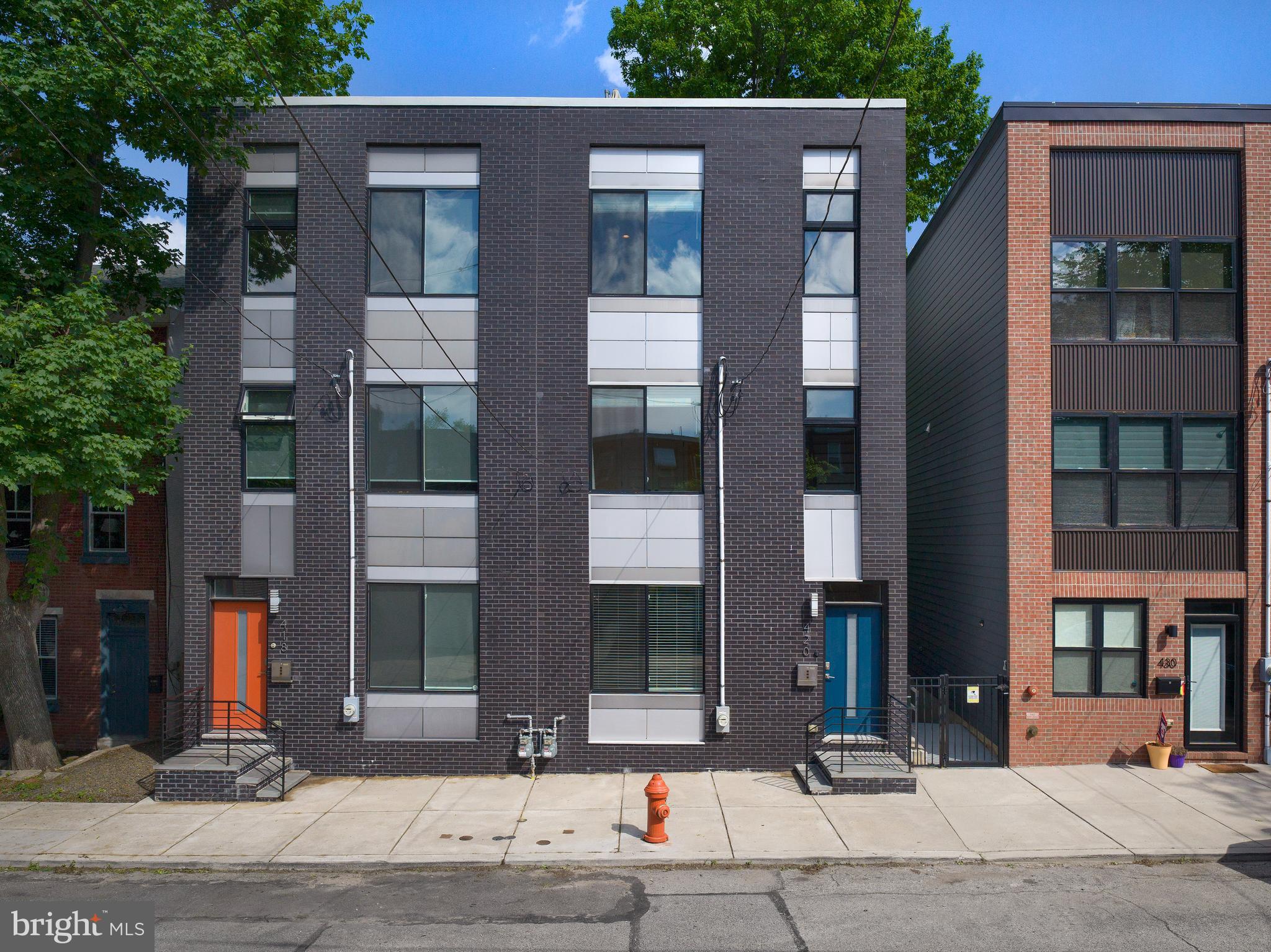 Sleek, spacious, and stunning—welcome to 420 Kingsley Street, where smart design meets effortless style in one of Philadelphia’s most dynamic neighborhoods.
This end-unit townhome commands attention from the curb with its bold black brick façade, modern paneling, and vibrant blue front door—a striking welcome to a home that’s equally impressive inside.
Step into the bright, open-concept living space where natural light pours in through oversized, wide-trimmed windows and a glass slider that frames lush greenery. Rich hardwood floors stretch throughout the main level, complemented by elegant crown molding, bullnose corners, and built-in speakers that blend form with function. Every detail has been thoughtfully curated—from the upgraded trim work to the sleek iron stair railing that leads you upstairs.
The kitchen is a true showstopper. Outfitted with shaker-style cabinetry, granite countertops, GE stainless steel appliances, under-cabinet lighting, and a large dining counter, it's a space designed for both daily living and weekend entertaining. Just off the kitchen, a conveniently placed powder room adds ease for guests—but the real bonus lies just beyond the sliding glass doors: a newly installed 14x16 Trex deck. This elevated outdoor space is perfect for al fresco dining, weekend grilling, or simply unwinding with a glass of wine as you overlook the beautifully maintained backyard. Built for durability and low maintenance, the deck offers a seamless indoor-outdoor flow that makes entertaining effortless and everyday living feel like a retreat.
Upstairs, you'll find two generously sized bedrooms, each filled with natural light and equipped with ceiling fan/light combos. A beautifully finished full bath and a discreet laundry closet make this level as functional as it is comfortable.
The third-floor primary suite is your personal retreat. It spans the entire level and features a tray ceiling with ambient lighting, an oversized walk-in closet, and a spa-like bath with dual showerheads, stylish tilework, and abundant natural light. Just outside the suite’s wet bar, step up onto your private roof deck—an ideal space to unwind, sip your favorite drink, or entertain guests while soaking in expansive skyline views and fresh air.
The fully finished basement features soaring 10.5’ ceilings, a half bath, added storage, and plenty of flexible space for a gym, rec room, guest area, or home office. It’s also a convenient walk-out level—great for indoor-outdoor flow and backyard access.
Behind the scenes, the home is loaded with upgrades: a security system, integrated home speakers, and energy-efficient windows offering cross-breezes from north- and south-facing exposures. And with a 5-year full tax abatement still in place, you’ll enjoy low ownership costs for years to come.
Location? It’s hard to beat. Just steps from the Wissahickon trails, and close to neighborhood favorites, cafés, transit lines, and schools—this is a truly walkable lifestyle with the best of city and nature at your doorstep.