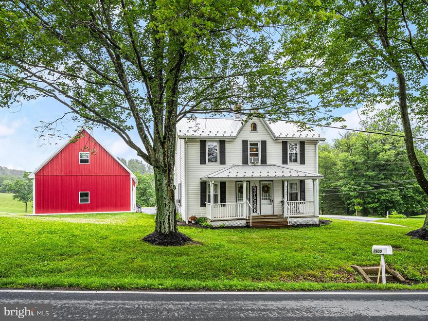 Welcome to 2900 Gillis Falls Road, a picture-perfect c.1900 farmhouse brimming with character and timeless charm. Perched on a scenic corner lot and set on three expansive acres, this delightful home features a metal roof, rich hardwood floors, and an incredible two-story, three-bay detached garage. Step inside to find a cozy living room adorned with exposed beams and built-in corner cabinet, while the inviting family room offers additional access to the covered front porch ideal for relaxing and enjoying peaceful country views. The eat-in country kitchen features warm wood cabinetry, tile backsplash, casual dining space, and a walk-in pantry, perfectly blending functionality with rustic charm. Just off the kitchen is the laundry room and full bath with convenient access to the backyard and garage. Also on this level is the spacious mudroom/side entrance.  Upstairs, you’ll find three generously sized bedrooms and an additional full bath. Outside, enjoy the covered front porch, ample parking, and a dream garage with a loft, three 9x9 doors, and a 7” fiber-reinforced concrete floor rated for a 5-ton jack. Recent updates include fresh paint, spray foam insulation, a 50-gallon plastic water heater with a lifetime warranty, and septic system improvements. This is the ideal blend of historic appeal, practical updates, and wide-open space.