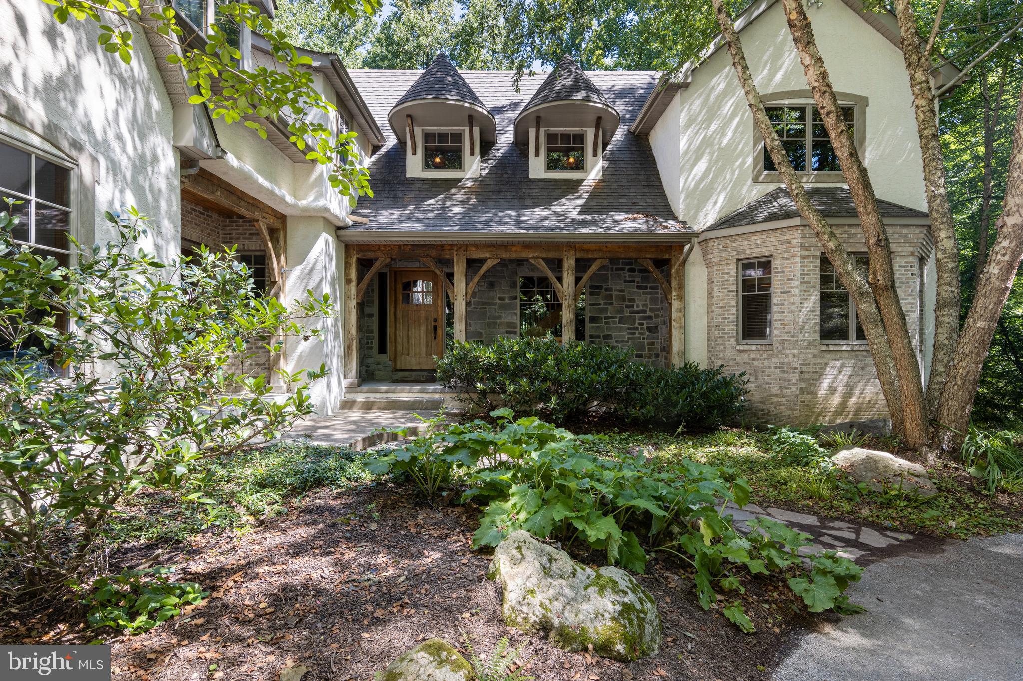 Back on the market with an aggressive price reduction! Property is sold in as-is condition. Inspection reports and repair estimates are available for review. Seller will not make repairs or provide concessions after agreed upon contract value. Experience the dramatic influence of exposed, curved and straight timbers that frame the exceptional living spaces of this stunning custom built timber frame home allowing for soaring windows, walls and open spaces. While a perfect blend of rustic charm and modern efficiency designed to resemble a ski lodge, this home is nestled on 2.68 acres and situated between iconic Fairhill and Newark, DE. This expansive and thoughtfully crafted 5 bedroom/ 3.5 bath property boasts an impressive 3,921 sq. ft. in a serene and private setting, ideal for those seeking tranquility and natural beauty. The home is constructed with the finest building materials including steel construction and structural insulated panels for both the walls and roof, ensuring superior strength and energy efficiency. Exposed load-bearing timbers add character and showcase exceptional craftsmanship throughout the house. Step inside to find an inviting great room with a floor-to-ceiling stone fireplace, creating a warm and cozy atmosphere. The main level with hardwood floors throughout features a spacious primary bedroom with an en-suite and gas fireplace, providing comfort and convenience, a gourmet kitchen, formal dining with coffered ceilings, powder room and laundry room. The upper level boasts an in-law suite accessible via a rear staircase thoughtfully designed for a future elevator shaft and wide doorways, offering flexibility and accessibility for multi-generational living, two additional bedrooms with high volume ceilings and loft space, playroom and a catwalk overlooking the great room which leads to an upper-level study/5th bedroom, perfect for flex space. The in-floor hot water radiant heat system with 1.5” gypcrete ensures cozy warmth throughout, making it a perfect retreat in all seasons in addition to forced hot air/ac. A full unfinished walk-out basement offers endless options for additional future square footage. No expense was spared during construction. Additional features include casement windows throughout, zoned radiant heating, basement bathroom rough-in, built in audio/speakers on main level, dog wash, and much more. Minutes from the University of Delaware, restaurants and shops yet so secluded and private. Don't miss the opportunity to own this exceptionally unique property that combines traditional craftsmanship with modern amenities in a peaceful and picturesque setting.