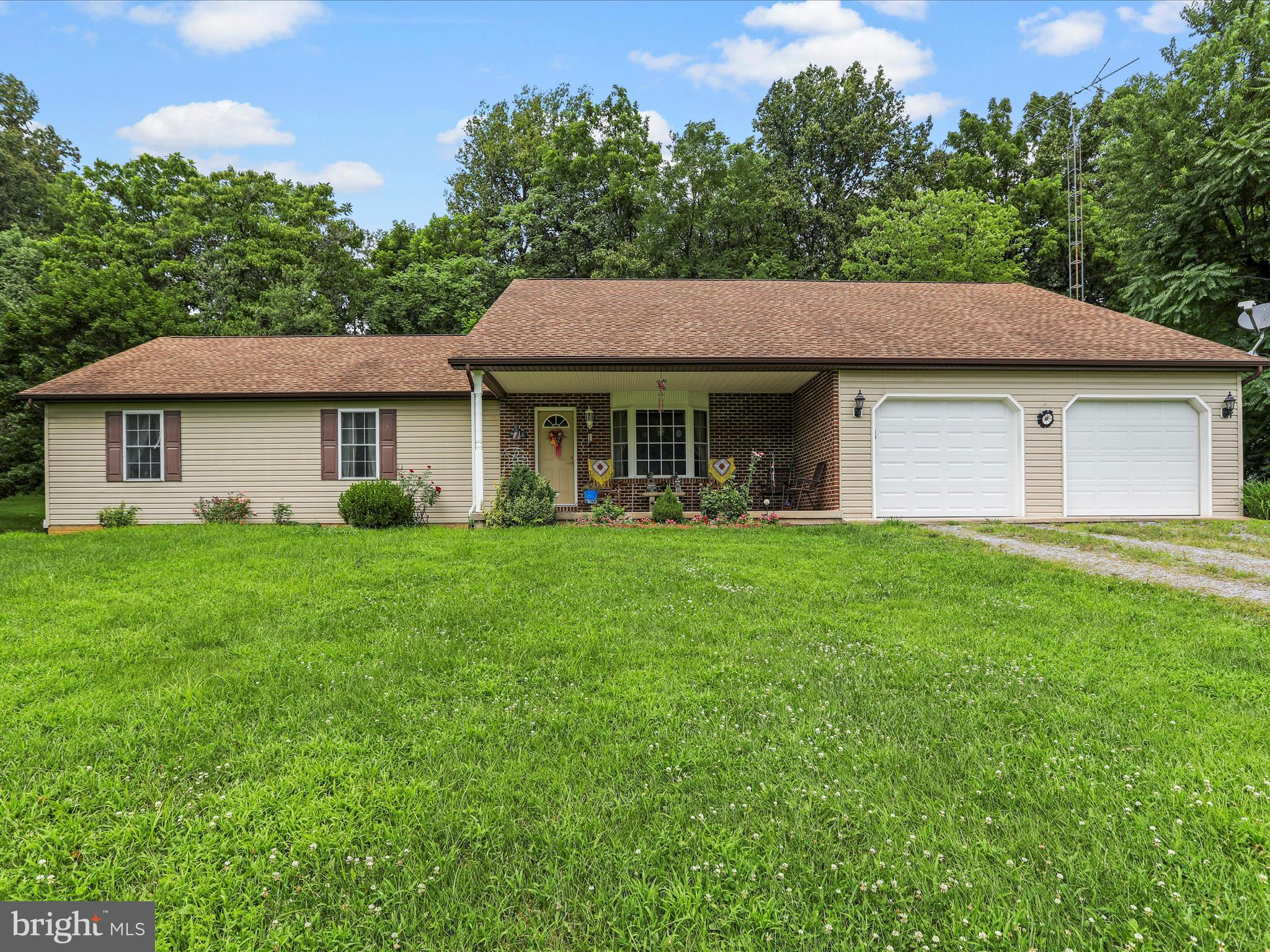 Welcome to your peaceful retreat in a countryside setting! This beautifully maintained 3-bedroom, 2-bath rancher offers 1,625 sq.ft. of comfortable living space on a scenic 5.09-acre lot that backs to trees, providing ultimate privacy. Step inside to a spacious living room with a cozy gas fireplace – perfect for relaxing evenings. The well-appointed kitchen comes fully equipped with all appliances, plus a dining table, chairs, and hutch that convey. The kitchen flows seamlessly into the open dining room, making it ideal for entertaining. Natural light pours in through skylights in both bathrooms and the laundry room, creating a bright and airy atmosphere. Outside, enjoy the convenience of a large 2-car garage with a workshop—complete with central A/C—ideal for hobbies, projects, or additional storage. A huge shed offers even more space for tools, equipment, or outdoor gear. With no HOA and no restrictions, you’ll have the freedom to make this property truly your own. Easy commute being minutes from Interstate 81. Don't miss this opportunity -- schedule your showing today!