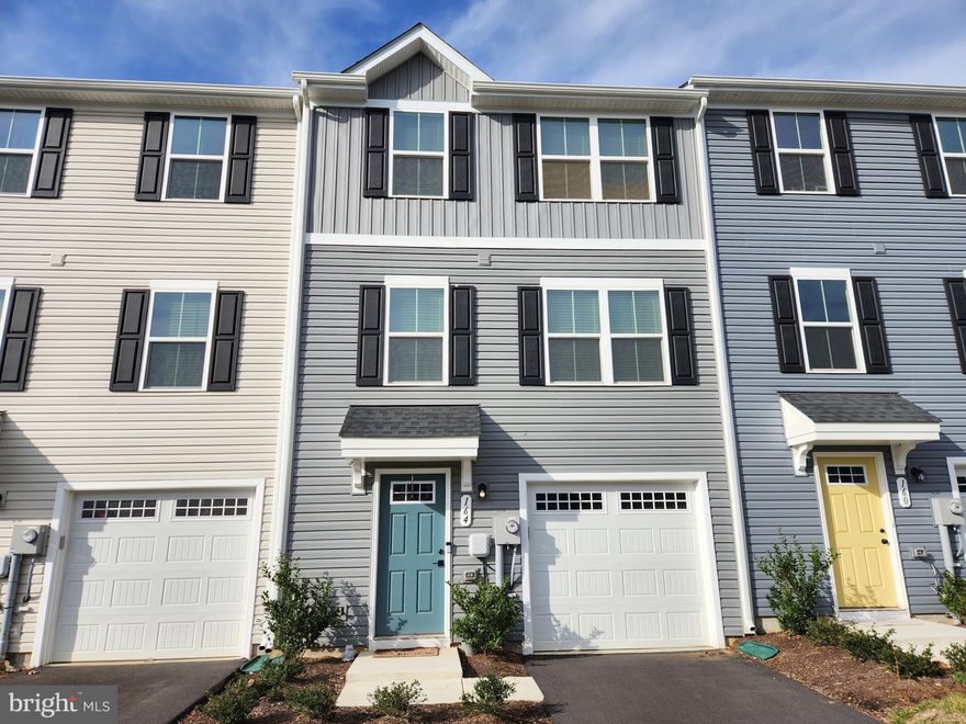 Welcome home to this ALMOST NEW townhome in The Lakes at Martinsburg! This 3 Bedroom, 2 1/2 Bath interior townhome has lots of light, easy care luxury vinyl plank on two floors and updated finishings. Enter in the spacious foyer on the first level, with access to the garage, flex space, backyard and coat closet. Go up the stairs to the open concept living space- great for entertaining! The kitchen features stainless steel appliances, and the prep island is included. There is a half bath conveniently located on this floor, and the mounted living room TV is included! Upstairs on the third floor, there is a well-laid out Primary Suite, with ceiling fan, full bath, and walk-in closet. The two secondary bedrooms and additional full bath are on the 3rd floor, as well as the hall laundry for convenience (washer/dryer included!). Outside, there is a large composite deck accessible through the dining area, with stairs down to the fully-fenced back yard. You can also access the back yard through a door in the flex space on the first floor. Right at the end of the street is the community playground, pavilion and dog park! Pets and pet deposits/monthly rent are case-by-case. Security deposit and 1st month's rent are due at lease signing. Available to move in February 1! Contact listing agent for application.