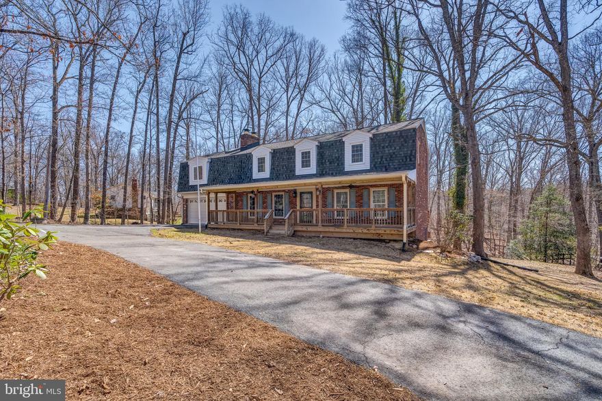 Beautiful single family home on a fantastic wooded lot in the Brentsville area. Spacious kitchen fully remodeled  with stainless steel appliances, an induction cooktop, convection oven, granite countertops, custom cabinetry, and baseboard drawers. Enjoy the large wood-burning stone fireplace while lounging in the spacious family room. Open living room & dining room off foyer which is perfect for entertaining. Over sized, front load 2 car garage. Downstairs features a full bathroom with multi use den/office. The spacious primary bedroom features vaulted ceilings, large walk in closet, a sitting room with a wet bar, and a balcony that overlooks your peaceful wooded lot. Upstairs you’ll find 3 additional bedrooms and a recently renovated bathroom with dual sinks, large vanity and spa like shower. Whole home features new carpeting and fresh paint! This home offers fantastic outdoor space including a front porch, decks, gazebo (with electricity), greenhouse and chicken coop! Close to shopping, dining and major commuter routes.