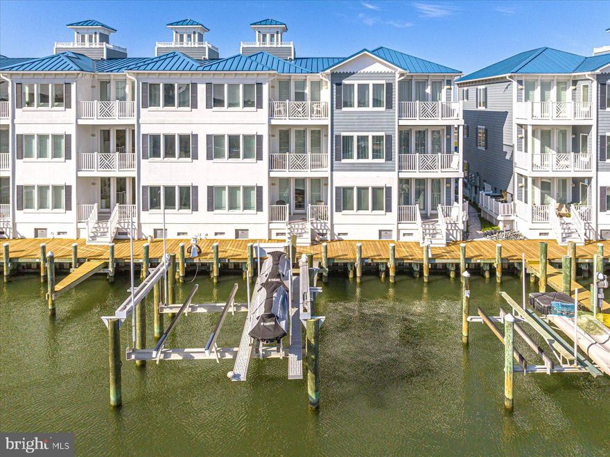 Luxurious custom coastal home with 36ft boat slip, boat lift and jet ski lift, and beautiful views of the Ocean City inlet and marina has just been listed.  This is a very unique opportunity to own this 3069 sq. ft. townhome, with elevator, in sought after Inlet Isle in West Ocean City. This beautiful townhome would make a perfect second home or primary residence.  This home was completed in 2019 and has ALL the latest finishes and upgrades.  The first level has one of the home's two family rooms which could also be used as a game room, home office or fourth bedroom complete.  It has a gas fireplace, full bath and custom shower.  The first level also has a deck off the glass slider which leads to the pier, boat slip with boat lift, and jet ski lift. The laundry room is also conveniently located on this floor.  Take the stairs or the elevator to the second floor, where you will find a luxurious primary bedroom suite overlooking the water with en suite bathroom complete with heated floors, steam shower and soaking tub. On the second level there's also another bedroom with en suite bath and shower.  Continue via the stairs or elevator to the third level, where you will find a spacious family room with gas fireplace, dining area, upgraded kitchen with an abundance of cabinets, quartz countertops, center island, stainless steel appliances and breakfast bar. This floor also has another bedroom with full bath and shower. There is a deck off of this family room that overlooks the marina and has fabulous sunset views.  For even more intense views stroll up to the cupola on the rooftop and enjoy the sights and sounds of Ocean City and the stars.  It is close to the inlet, restaurants, shopping, water sports, the Ocean City beach and boardwalk. It is also in the perfect location to watch the fireworks and the boats in the inlet and marina. Come take a look before this incredible home is Sold!  The seller has recently replaced the HVAC system, had epoxy coating installed on the garage floor, and added the oversized boat slip and lift that will accommodate a 36-foot boat, and jet ski lift that will accommodate 2 jet skis, boat lift capacity is 20k.