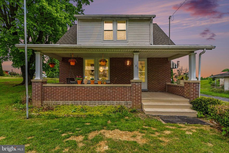 Charming, updated, and full of character, 186 W York Street offers space, comfort, and scenic surroundings in the heart of Biglerville. Situated on a spacious 0.63-acre lot, this 3-bedroom, 1.5-bath Cape Cod provides room to spread out both inside and out, with beautiful views overlooking a neighboring pond.

Step onto the cozy covered front porch, perfect for morning coffee or relaxing evenings, then head inside to find generously sized rooms filled with natural light, high ceilings, and hardwood floors. The layout flows easily for everyday living and hosting, featuring a bright sunroom for year-round enjoyment. The kitchen has been thoughtfully renovated with a brand-new stove, sink, countertops, refrigerator, and updated flooring, while the first-floor half bath adds convenience. A main-level bedroom offers flexibility, with two additional bedrooms and a full bath upstairs.

Recent improvements, including a newer roof and fresh paint, make this home truly move-in ready. The enclosed back porch adds even more usable space, ideal as a mudroom, sitting area, or bonus room.

Outside, the oversized lot provides plenty of space to enjoy, along with a well-maintained two-car garage with electricity, perfect for a workshop, studio, or additional storage (currently used as an art studio). Located across from apple orchards and the National Apple Museum, and just minutes from local shops, schools, parks, and an easy drive to Gettysburg and Route 15, this home offers the perfect blend of small-town charm and convenience.

A wonderful opportunity to put down roots in rural Adams County, schedule your showing today!