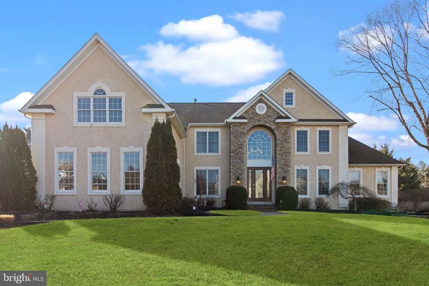 Magnificent two-story Center Hall Colonial with stacked stone is set on 1+ acres in prestigious Northampton Hunt and Award Winning Council Rock School District. Original owners exude much pride in this 4700+ square foot home with many upgrades and amenities. The backyard is entirely fenced with its resort style swimming pool and Sundek patio surround, two composite decks, one with a hot tub, and decorative paver patio are great for entertaining family and friends. The grounds are professionally manicured and offer underground sprinklers and lighted walkways. The two-story foyer with eight-foot custom entry door, chandelier with an electronic cable system for easy access, faux painted ceiling, curved hardwood staircase, 18”x18” ceramic tile flooring which continues through the kitchen and sunroom. The home is accessorized with many features throughout to include the pre-wired holiday package, decorative molding, security system, surround sound inside and outside, Eight-foot door height on first floor, 200amp electrical service, and well cared for hardwood floors. The Kitchen is equipped with 42” cabinetry, granite counters, stainless appliances, under cabinet accent lighting, pantry with custom built-ins, center island, and custom room divider having columns and overlooking the family room. Two-story Family room has huge palladium windows, Decorative beamed ceiling with recessed lighting, Natural gas fireplace with floor to ceiling stone surround and custom wood mantle, Built-in cabinetry to house the entertainment equipment, conveniently placed floor outlets, and custom window treatments. Living room is positioned off foyer and provides access to Conservatory through an arched entry. The Conservatory is a favorite room in the house with its walls of windows and cathedral ceilings. Dining room can accommodate an oversized table for large parties and includes a butler pantry, chandelier with linen medallion, and an additional entry to the Conservatory. The Sunroom is located behind the kitchen and offers splendid views of the swimming pool. It has two skylights and newer sliding glass door to one of the composite decks. The office is in the front of the home and behind French doors with custom built-in cabinets and accent lighting. The remaining space on the main level includes the Powder room and laundry room. Take the front or back staircase to the second floor and find the Master Bedroom Suite to include a large bedroom with trayed ceiling, sitting room, His and Her walk-in closets with custom built-ins and a Master bathroom to enjoy. Enter through double doors and find his and her extra height vanities motorized blinds over the jetted soaking tub, large shower with dual shower heads and separate toilet closet. And there are three additional bedrooms; a Princess Suite with dedicated bathroom and walk-in custom closets, while the other two bedrooms each have walk-in closets and share a 'Jack n Jill' bathroom. The lower level is constructed with additional height to accommodate the professionally finished area. The highlight of this level is the custom-built wet bar with wood cabinetry, granite counters, stainless sink, dishwasher, and refrigerator, and tiled backsplash. Also, find a recreation area accommodating a pool table, a den for watching television, another bedroom and full bathroom. Egress to the back yard. The basement has lots of available storage with built-in shelving to organize all your seasonal decorations. Three-car garage designed with clear span (no posts) and extra height garage doors having electric openers. Find more storage in the garage. Close to Maureen Welch Elementary School and around the corner to Northampton Municipal Park offering an Amphitheater, Butterfly Garden, Baseball, Softball, and Soccer fields, Hockey rink, Volleyball and Basketball courts, Walking trails, Picnic pavilion, Playground, and Concession area. In town you’ll find many shops and restaurants.