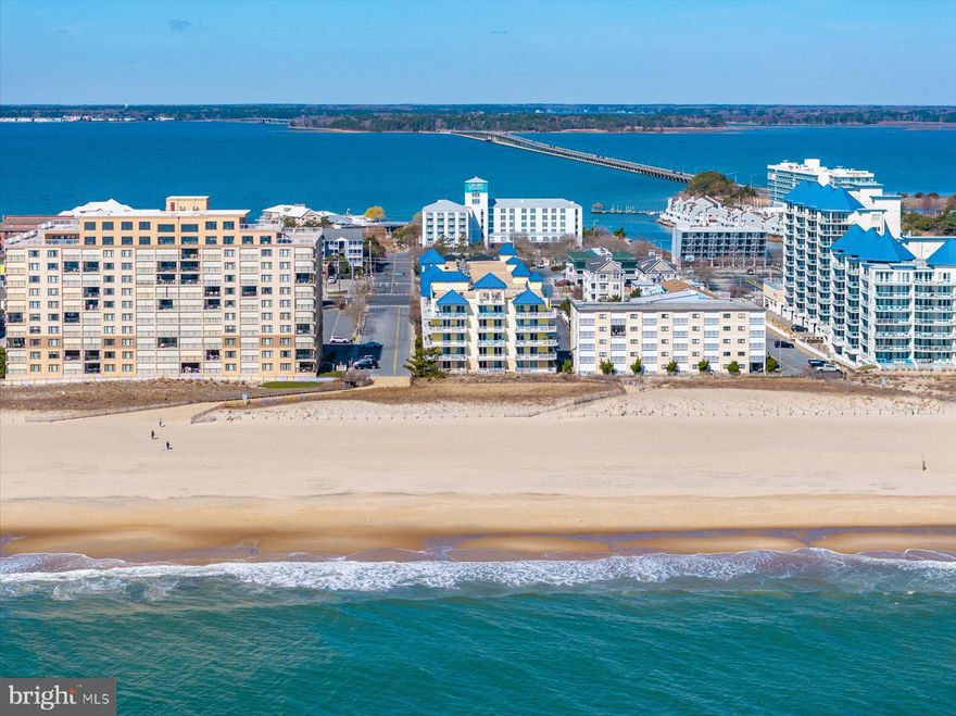 Rare find—don’t miss this beautifully updated 3BR/3BA condo in The Adagio, just steps from the beach in mid-town Ocean City. Located on the 4th floor, this stunning residence offers sweeping ocean and city views from a large, south-facing balcony—perfect for enjoying sunrise mornings.  Inside, the open-concept layout features a chef’s kitchen with granite countertops, luxury stainless steel appliances, custom backsplash, ceiling-height cabinetry, breakfast bar, pantry, and tile flooring throughout. The spacious living area is highlighted by a cozy fireplace, crown molding, and plantation shutters—ideal for year-round entertaining. The oversized primary suite offers private balcony access, a generous walk-in closet, and a luxurious en suite bath complete with dual vanities, soaking tub, and separate shower. Two additional bedrooms and full baths provide ample space for guests and family.  Additional highlights include a private laundry room and two parking spaces. The Adagio offers premier amenities including a heated indoor pool, spa, sun deck, fitness center, and social room.  Ideally located just off Route 90 and close to top restaurants, shopping, and all that Ocean City has to offer