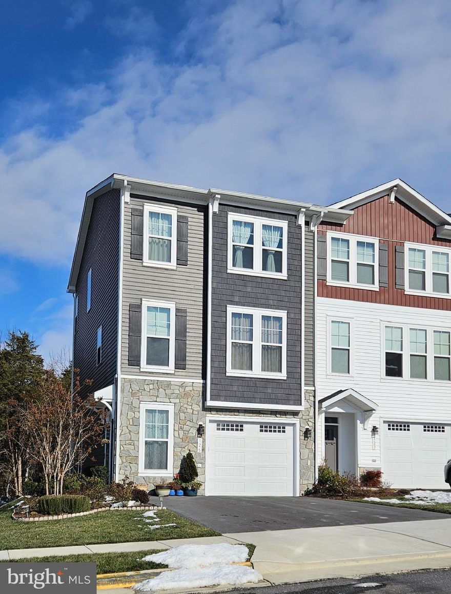 Better Than New! This 2-year-young Van Metre Sugarloaf END unit has been lightly lived in and meticulously maintained, featuring numerous upgrades on a premium lot backing to trees. With over 2,100 sq. ft. of bright, open space and windows on three sides, this home is light-filled and airy—a true standout! ******* Main Level – Open and Inviting! The versatile open floor plan seamlessly connects the living room, dining area, and gourmet kitchen, all with LVP flooring. A powder room sits conveniently by the stairs, and a cozy nook—perfect for a home office—adds flexibility to the space. Calling all chefs! The premier gourmet kitchen boasts: stainless steel appliances with a chimney hood; well-configured gas cooktop, wall oven, and microwave; quartz countertops & extended center island (ideal for meal prep & casual dining); large, deep under-counter sink (perfect for big pots & dishes); abundant storage, including a double-door pantry. Love to grill or dine al fresco? Step out onto the low-maintenance composite deck, where you can relax and enjoy peaceful wooded views.  *******   Bedroom Level – Comfort & Convenience! Take the oak stairs up to the bedroom level, where you'll find: primary suite with a tray ceiling, spacious walk-in closet, and luxurious en-suite bath; windowed en-suite bath featuring granite counters, dual sinks, and a walk-in shower with a built-in seat; Two additional bedrooms plus a full bath with a tub; laundry closet conveniently located on this level.  *******   Lower Level – Flexible & Functional! The street-level includes: family room (or optional 4th bedroom) with an attached full bath; foyer with LVP flooring, coat rack space, and bench area; garage access & patio. Step onto the stamped concrete patio backing to trees. The A/C compressor is positioned on the level patio for efficiency & safety.  Additional highlights: ✔ Andersen storm door ✔ water softener & whole-house water filter installed ✔ Google Nest Thermostat  ✔ dual-band access point on every level ✔ 220V socket in the garage (ready for future EV charger) ✔ garage, wide driveway, & ample unassigned parking. ******* Lake Frederick – A Scenic, Amenity-Rich Community Nestled in the Shenandoah Valley Near the Blue Ridge Mountains, Lake Frederick offers a peaceful, gated community with endless outdoor recreation—hiking, fishing, boating, and more! Enjoy friendly neighbors, pickleball & tennis courts, dog parks, a clubhouse, and an outdoor pool. Prime location with easy access to I-81 & Routes 66, 50, & 7. ✨ Move-in ready and better than new—don’t miss this incredible home!