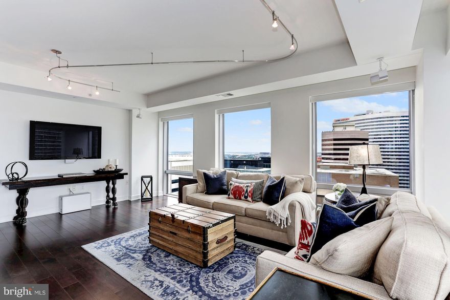 Beautiful corner unit in the Waterview w/ views of Georgetown & Rosslyn! Open floor plan w/ gourmet kitchen, living room w/ space for dining table, 2 BRs, 2.5 BAs, & 2 car garage parking! Featuring hardwood floors, floor to ceiling windows, & high end appliances. Luxury living w/ fitness center, 24hr concierge, & rooftop terr. Fab location near Metro & easy access to Georgetown, Clarendon & more!