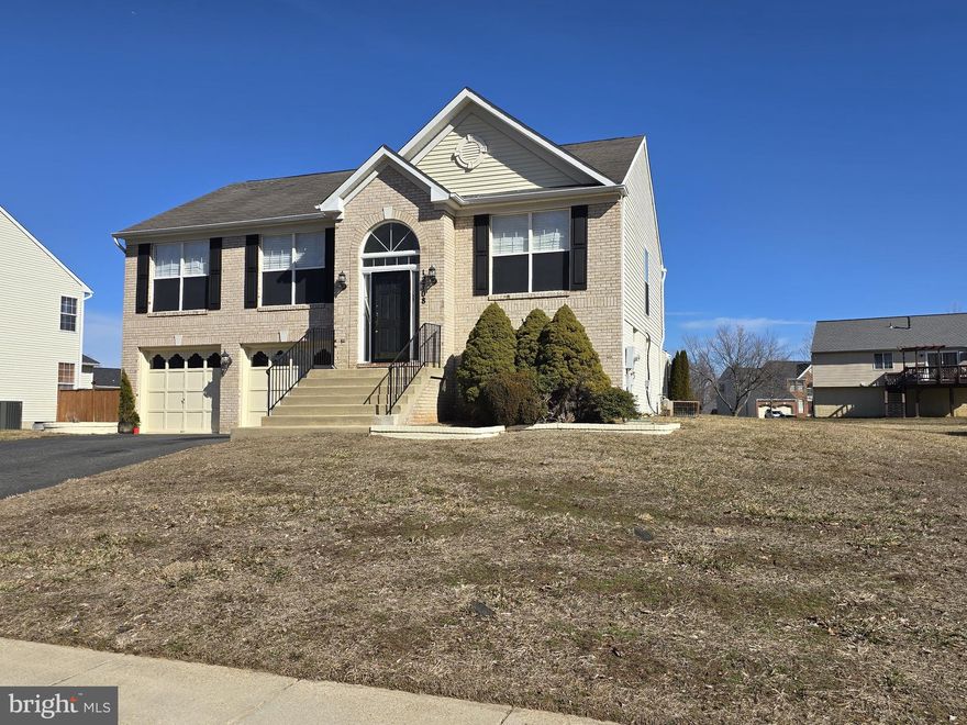 Ready for the new owner.. 100% FHA FINANCING AVAILABLE for this property. This brick front split foyer home is in move in condition with upgraded finishing touches.  The bathrooms are updated with tile floors, vanities and lighting. The master bathroom has a soaking tub and a separate shower and double sinks. The large tiled kitchen has french doors and access to the formal dining rooms. Crown and chair  molding throughout. Upgraded  lighting  and custom touches.  A must see to appreciate home