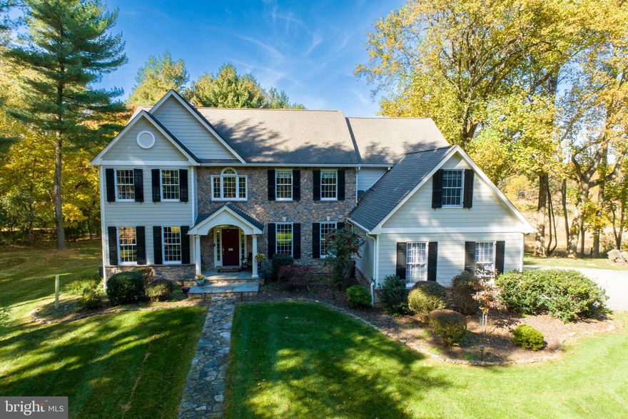 Welcome to 451 Webb Road in Chadds Ford Township! Not often does this combination of location and superior home come on the market. This incredible 6 bed, 4.1 bath home sits on 2+ secluded acres with dramatic views over Brinton Run Preserve, which features 70+ acres of preserved green space that include walking trails and also saw some of the action during the Battle of the Brandywine.  Located in the blue ribbon Unionville-Chadds Ford school district, the location offers lots of privacy while retaining easy access to shopping and destination sites such as Longwood Gardens, Winterthur, and the Brandywine River Museum. Privacy and serenity abound as you pull into the driveway and take in the mature trees and attractive landscaping. The exterior features updated masonry and Hardie plank siding (2019), as well as an inviting slate front porch that beckons you into the home. Stepping inside, you will immediately notice the gorgeous hardwood floors that run from the bright and airy foyer throughout the main level. The dining room to your right boasts intricate crown molding and wainscoting and is the perfect spot to host festive gatherings. Passing the butlers pantry into the kitchen, your eye is immediately drawn to the gleaming granite countertops and spacious, two-tiered island with plenty of seating to keep you in the conversation while hosting. With stainless steel appliances and a walk-in pantry for incredible storage space, the kitchen is ready to serve all of your needs. A separate laundry room off the kitchen, leads to the side door and the 3 car garage with built in storage space. From the breakfast area you can step through new sliders onto a huge new low maintenance deck (2023) overlooking the backyard and Preserve. Take in morning sunrises to evening sunsets and easy access to the backyard down the steps. The kitchen and breakfast area are open to the sunken family room, with custom Italian tile flooring (2020) and a jaw-dropping stone fireplace with gas insert (2022). Tall windows in the family room give you the perfect vantage point for the most spectacular views in Chester County.  On the main level is a large office and custom designed half bath. The living room completes the main level with custom crown molding and large windows to draw the natural light in. Upstairs, your personal oasis awaits in the generous primary bedroom suite with tray ceiling and room enough for a comfortable sitting area. Through french doors from the primary bedroom is a bonus room - nursery, 2nd office, workout space - you decide. The customized walk-in closet (Closets by Design) is next to the master bath - this has been upgraded with mahogany and marble vanities, vessel sinks, a soaking tub and a separate water closet. Down the hall, you will find four more generous bedrooms. Two of the bedrooms are joined by a Jack-and-Jill bathroom with updated granite and fixtures. The third full bathroom has dual sinks and serves the two remaining bedrooms. Downstairs, the expansive full daylight basement is the hangout spot of your dreams including a media room with hardwood floors, dry bar and dining area with Italian slate floors, and walkout access to the stone patio for relaxing summer nights. The patio leads to the stairs leading to the upper deck or a stroll down to the back of the property to the firepit and the Preserve. A sitting area, sixth bedroom and full bath in the basement would make a great spot for your guests, an in-law suite, or an exercise room. A large unfinished area allows easy access to all the mechanicals, loads of storage and also space for a crafts area. Other great features include the whole house vacuum and radiant heat that flows throughout the entire home, including the basement, keeping the floors and entire house warm in winter and cool in summer without the issues of forced air heat. In addition, the sellers have a home warranty that is transferrable to the buyer. Check out the video tour and schedule yours today!