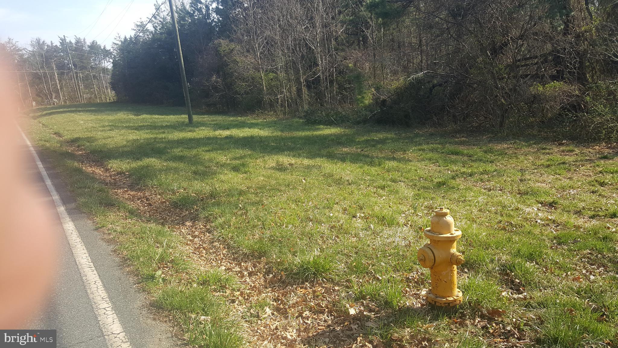 This is a 7.7 acre multi-use curved corner lot with potential to apply for re-zoning to either SR-5 or SR-3 to subdivide into separate lots for single family residential, or a church or daycare or many other special uses allowed by the county (see Prince William County Code). Buyers should research the Prince William County Comprehensive Long Range Plan to discover all the potential for this beautiful lot. Tucked away in the beautiful woods of Prince William County, this private wooded lot has public water and sewer available. Buyers should check with the county for details. Soil testing was done in 9 different spots for many choices of drain fields for conventional septic also.. It is just minutes from Rt 234 and 642 (Hoadly Rd), minutes from Coles Elementary and Benton Middle Schools, and Colgan High School. Nearby shops are also only minutes away. It is currently zoned A-1. There is a nearby fire hydrant, an entrance road and gate, and lots of road frontage on Van Doren Rd for 911 addresses. Soil report available