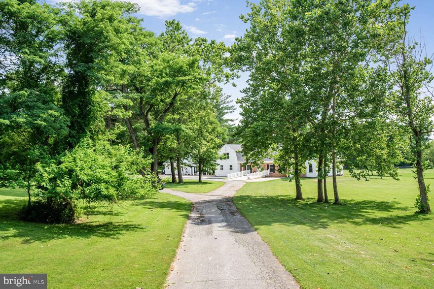 Idyllic 7.58 Acre lot with dual zoning residential/commercial. Currently being used as a church- there is a fully functioning captivating sun-filled residence and guest quarters on property, First Floor Great Room has soaring ceilings custom built-ins and wood-burning fireplace. First floor includes 2 half baths - Primary Suite with ensuite bath ,fireplace, and large Primary closet, Library,, Large Gourmet Updated Kitchen  ,Dining Area ,mudroom and greenhouse
Upstairs-Second Primary Bedroom  with ensuite bath- two addtional large bedrooms and additional full bath  on upper level.
New Carpet- Fresh Paint
Guest quarters/ Inlaw Suite attached to home
Additional large Enclosed Structure perfect for Artitst Studio- Home Office or Approved Commercial Use.
Bring your buyers and their dreams for a large peaceful lot- over 4000 sq ft home and opportunity for multiple uses.