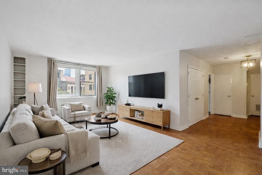 Enjoy expansive living in this recently updated and exceptional corner two-bedroom residence at 2601 Parkway. Boasting over 950 square feet of magnificent living space, this home welcomes you with a foyer that leads into a sprawling living and dining room, showcasing beautiful parquet flooring, built-in shelving, and an abundance of natural light. The kitchen features sleek cabinets, ample counter space, a gas range and a full-size refrigerator and dishwasher. The primary bedroom is large and offers serene views of the neighborhood along with two closets and additional storage. The spa-like bathroom  boasts a freshly reglazed tub and shower tiling, ceramic sink with storage vanity and updated chrome fixtures.  The second bedroom is ample sized and offers additional flexibility to be used as a guest room or office. Association fees include water and sewer, gas cooking, a convenient shuttle service, a state-of-the-art fitness center, bike storage, and a 24-hour lobby attendant. Perfectly situated across from The Art Museum and Fairmount Park, this pet-friendly residence is close to Kelly Drive, Boat House Row, Whole Foods Market, The Barnes, great restaurants, and major transportation.