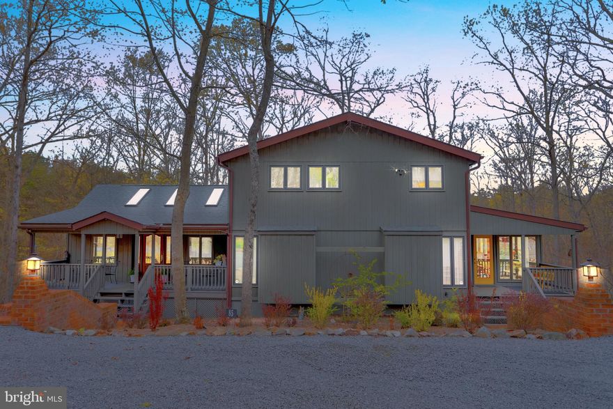 Exceptional home in The Woods Resort, Walden Woods area. Three decks, screen porch, and skylights brings the outdoors in to this lovely home.  Warm and inviting with four fireplaces, great room, living room, dining room, den/recreation room.  There is a large screen porch on the back, two decks on the back and one deck on the front.  The lower level den walks out to one of the decks and the screen porch is off the dining room.  The primary bedroom on the second floor has been modified for privacy in this customized Elmwood model.  There are two additional bedrooms and a full bath on the main level.  Hardwood floors throughout add a warm luster to this tastefully decorated and well maintained home. Kitchen recently remodeled with quartz counter tops and stainless steel appliances.  The three bay detached garage with room for 6 cars will provide space for cars, workshop, hobbies, many options here.  All nestled in The Woods with Class B membership available.