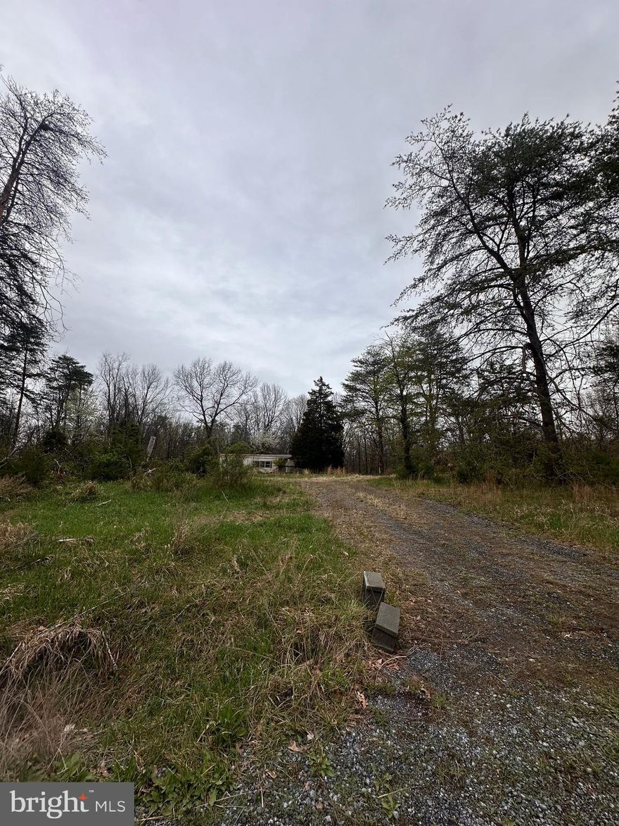 **appointment required for all showings. Buyers must be accompanied by an agent** 
5 unrestricted acres in Bunker Hill with well and septic already in place—ready for your next project. The existing structure on site needs to be demolished, offering a clean slate to build your dream home, place a modular, or bring in a manufactured home. Quiet, rural setting with easy access to commuter routes, schools, and local amenities. Great opportunity for a fresh start with no HOA and plenty of space to make it your own.