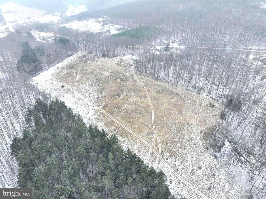 When only a premium property will suffice, consider this exceptional offering for the good life in West Virginia. This 10+ UNRESTRICTED Acres parcel boasts ample county road frontage and a manageable topography, ensuring convenience and ease of access. Navigate effortlessly through the tract using the remnants of an old access road, which can be further improved upon. Discover multiple beautiful, elevated, and secluded build sites, featuring a hidden meadow surrounded by towering oak hardwoods, creating the perfect habitat for wildlife. Indulge in every outdoor recreation imaginable—Hunt, Hike, Shoot, Ride ATVs, or simply relax in the quiet serenity of the mountains. The easy access via US Route 50 means you can go from your mountain paradise to Dulles Airport in under 2 hours. This destination property not only offers the freedom you seek but does so at a price you can afford. Don't miss out on the opportunity to make this premium piece of Hampshire County, WV, your own.