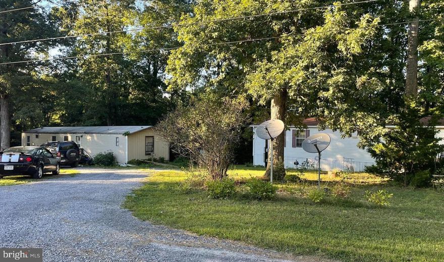 Great investment property or build your own!  1.5 acres in a quiet neighborhood with public water and sewer.  The property is currently set up with 3 mobile homes which are tenant-owned. Tenants pay lot rent on month-to-month leases. Each tenant pays their own water/sewer/electric.  You could choose to continue current arrangement, replace with your own mobile[s] or build a home.  The back of the acreage is wooded and could possibly be timbered.  Please do not enter the property without an appointment or an agent.  Also listed under Land Sale:  MLS WVBE2032778