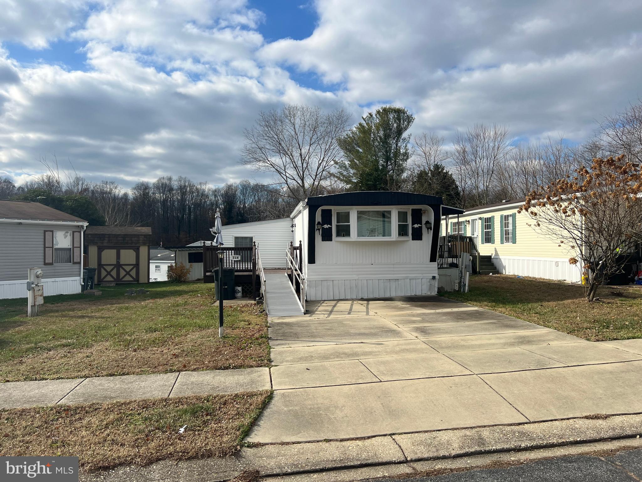 Welcome to 214 Konrad Morgan Way in Boone's mobile estates! This home offers an updated kitchen with stainless steel appliances and tiled backsplash along with two updated bathrooms. The two bedrooms have wall to wall carpeting with the bathrooms right outside the door. The large sunken living room off the kitchen makes entertaining easy. The conveniently located full size laundry is in the hallway. In the backyard you will find a spaces shed to hold your lawnmower and outside furniture for the large deck this home boast. Parking for two in the driveway and if you need more storage Boone's mobile estates offers storage for boats,RV's and trailer with secured indoor storage for other items. Enjoy the playgrounds for kids and the tennis and basketball courts. In the Summer the pool offers a nice escape from the heat. This community has all you need. "PLEASE NOTE YOU MUST BE ACCEPTED BY THE COMMUNITY FIRST!!!"