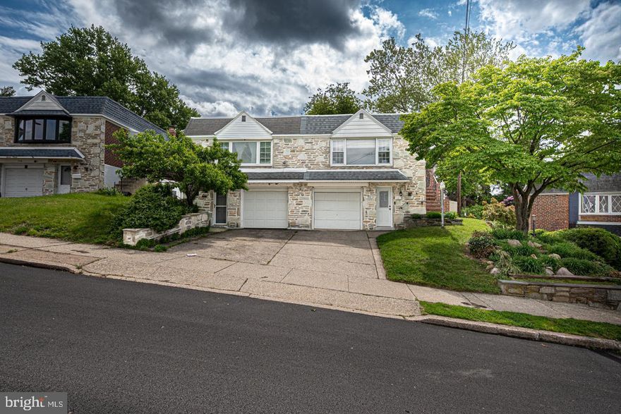 This is THE ONE!!  Stately Brick & Stone Twin in Sought-After Roxborough, known for its Friendly Community Vibe and Suburban Feel, but Minutes to All that Philadelphia has to Offer.  Updated and 100% Move-In Ready, this Home Checks All of the Boxes!  Side Door Entry into the Open Living Room, Kitchen, and Dining Room, All with Great Natural Light and Elevated Neighborhood Views.  Ivory Cabinetry, Stainless Steel Appliances, and Dark Natural Stone Countertops are the Perfect Selections in the Kitchen, and the Island Seating Brings the Space Together while Adding Additional Storage.  Primary Bedroom with En Suite Bath Plus Two Additional Bedrooms and Hall Bath on Main Floor.  Finished Lower Level with HUGE Family Room with Wood-Burning Fireplace.  Tons of Closet Storage, Including One Cedar, Plus Powder Room Make this Space Extra Functional.  Walk-Up Exit from Lower Level to Oversized, Fully Fenced Rear Yard with Built-In Brick Grill--Very Hard to Find in this Urban Setting!!  One Car Attached Garage Plus Driveway Parking.  Plank Flooring Throughout (no old carpets!) and Freshly Painted.  Truly an Excellent Value at $435,000 in a Fabulous Location in Close Proximity to  Wissahickon Valley Park, Schuylkill River Trail, and Manayunk.