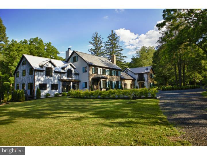 STUNNING ONE OF A KIND DESIGNER OWNED ESTATE LOCATED ON APPROX 13 ACRES WITH HEATED POOL/SPA,PONDS,GUEST COTTAGE AND TOTAL PRIVACY. This Bucks County Farmhouse/Barn-like renovation is second to none. The spectacular grounds afford privacy and living in natural wonder, from the cascading ponds to the boundless mature trees, you will relax and play like never before. Originally built in 1700s as a simple stone log cabin,this home has had dramatic additions and restorations resulting in the ultimate in a relaxed rustic elegance that stays true to historic origins but with a glorious modern twist. The vast custom kitchen has been featured in several magazines, has 2 large seating areas with wood burning fireplace,doors to rear terrace for entertaining and enjoyment. Open dining room accommodates large dining parties with lots of light and easy access outside. This entertaining space flows into the living room and the handsome expansive library and office. Exposed beams and architectural lighting abound. The original log house sits seamlessly within the home and leads the way to a loft one bedroom suite. The first floor master with FP has French doors to the outside rear terrace. 3 additional bedrooms complete the second floor. Country grounds with 3 ponds, gorgeous heated pool/spa,and pool house. Fully furnished in a neutral palette. Separate cottage guest house with full kitchen, 1 bedroom, bath,living room with FP and add'l sleeping loft. Minutes away from Lake Nockamixon State Park where there is boating, sailing, sailboarding, windsurfing, horseback riding, as well as hiking and biking trails. Less than 35 minutes to Lehigh Valley Airport, major carriers. Owner vehicles available for use - to be negotiated. Buyer responsible for square footage.