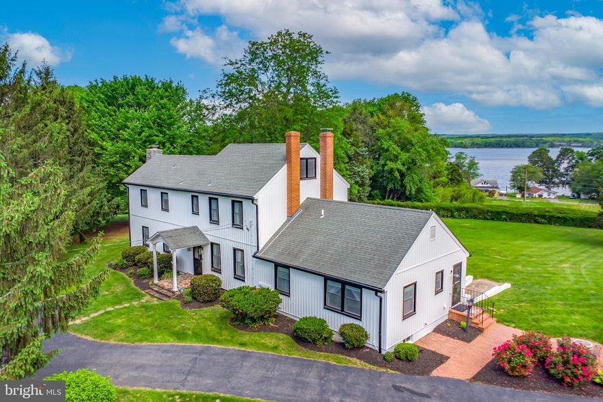 Welcome to 65 Hillcrest Lane located just outside of the quaint town of North East.  If you are looking for a home with charm and character, your search is over.  This one is loaded with both, and offers all that one could ask for.  The lot is a sprawling 2.98 acres of open space, surrounded by a lush hedge that offers unrivaled privacy.  The classic center hall floor plan is both grand and spectacular in this setting.  The foyer offers gleaming floors, high ceilings and intricate trim.  The kitchen features gas cooking with designer appliances, soap stone counter tops and a view of the North East River from the window.  This is a place the gourmet in the family will love!  The family room has a gas fireplace that takes the chill off of the cold winter nights.  A breakfast table sits in front of a large window overlooking the rear yard making this the perfect place to both start and end your day.  You can see the river from here as well!  The dining room is loaded with a generous amount of character, and just waiting for those special holidays or dinner parties.  The living room is a special space decorated for the most formal affairs.  It is grand in looks and size and features a second fireplace.  The rear porch has been modernized to ensure you get the most out of it regardless of the season.  The windows bring the outdoors inside to you when you are here.  The rear steps lead to a large stone patio where you will watch the Town of North East's Independence Day fireworks display with family and friends for years to come!  Upstairs the primary bedroom features a four piece bath that could rival the finest spa.  Oh yes, there is another view of the river from this space as well.  There are also two additional bedrooms and another full bath on this level.  One of the best features of this home is the main level fourth bedroom.  This room, just off of the den, offers ample space, and a full bath.  Outside, the driveway is long, wrapping around to the detached garage.  On the right side coming in is the perfectly flat outdoor party area where the largest tent you can imagine would fit with ease.  There is an electric dog fence surrounding this property.  The North East River Yacht Club is just a very short walk down the street, offering slips, a restaurant, and a welcoming atmosphere.  Come see this one today!