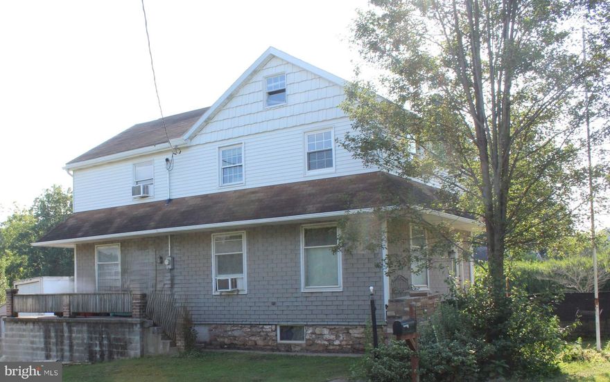 Welcome to your slice of country paradise! Nestled on 3.7 acres with stunning views of surrounding fields and valleys, this spacious 4-bedroom, 1.5-bath home combines historic charm and versatile spaces. 1st floor laundry room.  Land perfect for hobby farming, gardening, or simply enjoying the outdoors.  Multiple outbuildings for storage, animals, or workshops including animal barn with pasture and self- draining floor.  Metered water access outdoors for easy care of animals or gardens with 2 fire hydrants accessible.  Both locations include 2 outside faucets for a credit off your sewer bill.  Custom wood flooring in the living and dining rooms. Mudroom, foyer and bedrooms have their original hardwood floors.  Wood columns add character between the dining and living areas/bonus room.  Beautiful stained-glass windows on first floor.  Basement waterproofed in 2016 – ideal for a wood shop or additional storage and even more storage potential in the attic.  Wrap-around porch – perfect for relaxing and soaking in the views in this rural setting with plenty of space to expand or customize.  4 heating zones for personalized comfort throughout the home.  Whether you're looking to start a small farm, create a workshop, or simply enjoy peaceful country living with modern conveniences, this property offers endless possibilities and opportunity to make it your own.