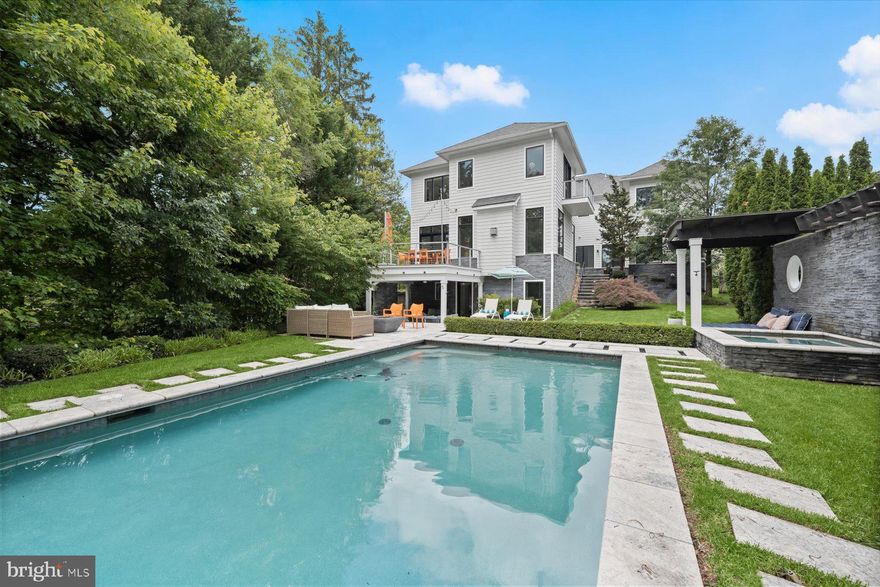 *Newly Listed* Open Sun 1-4PM* Welcome to 4012 N Upland St., a luxury home nestled in the coveted Country Club Manor neighborhood of North Arlington . This desirable home is in the Yorktown H.S., Williamsburg M.S., and Jamestown E.S. tier. Offering unparalleled access to Washington, DC, Tysons at McLean, 3 airports, and National Landing this home perfectly balances suburban tranquility with urban convenience, just minutes away from vibrant city life.

Custom built in 2014 by Joy Design-Build, this home spans an impressive 7000 square feet across three levels, boasts 5 spacious bedrooms all with walk-in closets, 4.5 bathrooms, a main level office and an incredible walk-out garden level. The design revolves around an exterior landscaped court and is accessed from the kitchen, family room, library and center hall. Floor to ceiling windows, clean lines and sleek details can be found throughout the house. Stepped up ceilings and unique window walls open the floor plan and views from every angle while keeping the family areas private.

A stunning two-level foyer welcomes you into the home that leads to the formal living room, formal dining room and butler’s pantry that connects to the modern kitchen. The open-concept kitchen is a true highlight, designed with both function and style in mind— perfect for those who love to entertain. Imported custom made Italian Scavolini kitchen cabinets are the backdrop for this gourmet kitchen with a large island that easily sits 5. Plus high end appliances to include; double ovens, double dishwashers, large 6 burner stove, a prep sink that includes an osmosis water filter and instant hot water, cooking is made easy. The kitchen connects to an eat in dining space and sun-drenched family room anchored by a floating gas fireplace. The adjacent elevated deck offers easy outdoor living and provides a serene retreat, overlooking a lush and private 1/3-acre landscape backyard oasis designed for ultimate outdoor relaxation, fun and entertaining. Also located on the main level is a private office with custom built-ins, mud room with built-in cubies and dog washing area, and access to the oversized two car garage outfitted with custom storage and organizational systems. 

The second level house an impressive primary suite with two walk-in closets, dramatic hallway leading to the spacious bedroom, private sitting deck, and a gorgeous luxurious bathroom with a glass shower complete with two shower heads, soaking tub, separate double sinks and makeup area, plus a private outdoor balcony with outdoor shower. Also on the second level you will find the second bedroom with a full ensuite bath, bedrooms three and four share a jack and jill bath, and an over sized laundry room with built-in dry racks, a folding station and custom cabinetry. 

The walk out garden level extends the living space for those who like to be fit and have fun. Enjoy working out in your own fitness room with attached steam shower. Spend the evening playing pool in the billiards room or relaxing and watching a movie in the home theater, then enjoy some wine at the bar next to the built-in wine cellar. The lower level connects to a covered outdoor living room with built-in gas fireplace and built-in day bed that leads you to the pool deck. Also on the lower level is the 5th bedroom and large storage room. 

The expansive .30-acre lot is a private oasis, meticulously landscaped to create a peaceful and inviting outdoor sanctuary. An inviting, heated pool is the show piece, while the private hot tub and attached day bed or the sweeping stone patio with a built-in gas fire pit that anchors an outdoor living room and tanning beds easily add to the grounds allure and outdoor retreat feel. 

With its unbeatable location, expansive living spaces, and luxurious amenities, this property offers the perfect blend of comfort, style, and convenience.
