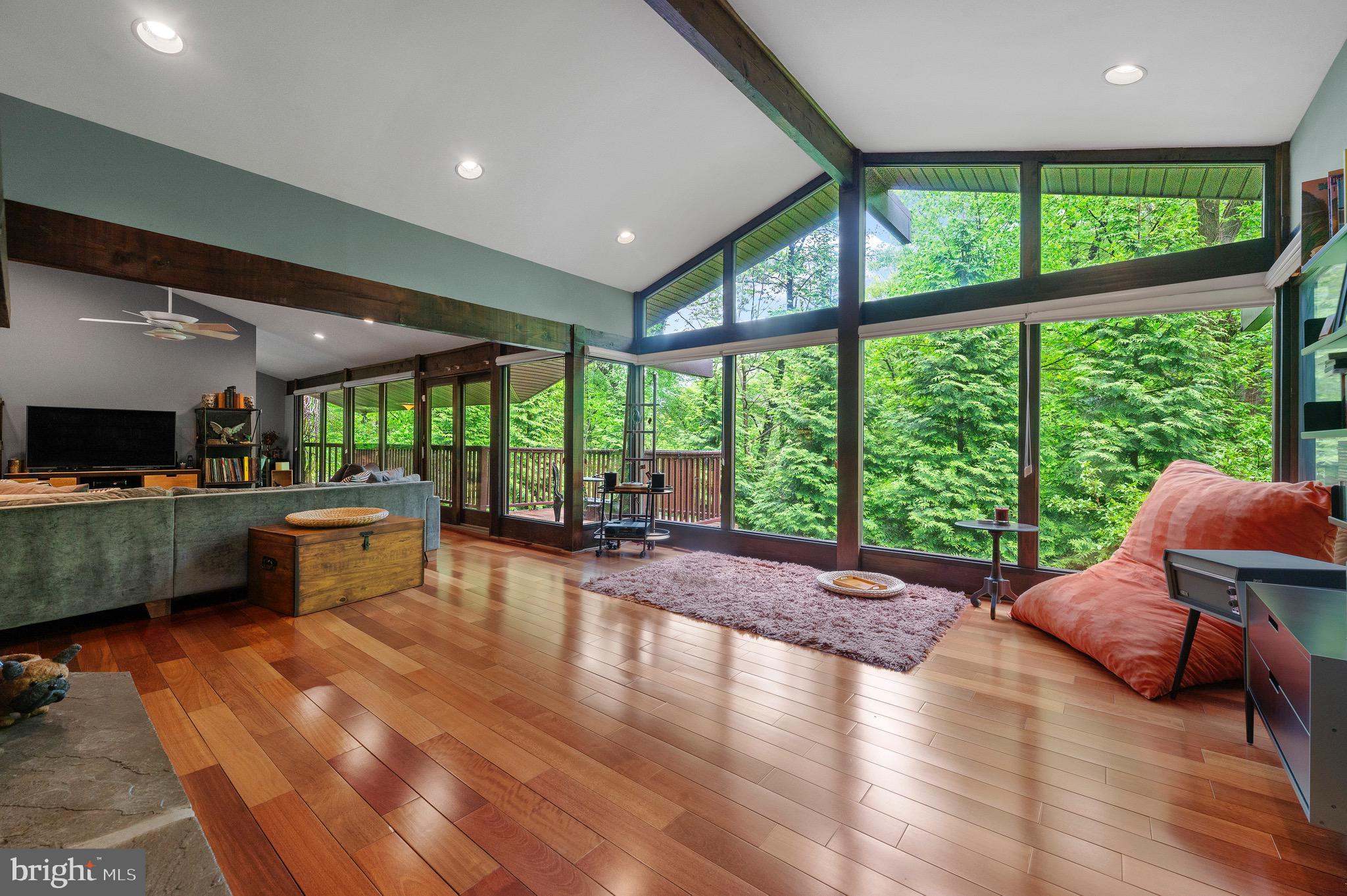 Welcome to this beautifully updated McElroy Contemporary, offering 4 bedrooms, 2.5 bathrooms, and a serene, treetop setting on a quiet street—just a short walk to local schools, train and restaurants. Blending timeless design with thoughtful updates, this home combines natural beauty, modern finishes, and flexible living spaces. Step into the main living level and you’ll immediately notice the oversized windows that flood the home with natural light and offer spectacular views, creating a tranquil, treehouse-like ambiance. Two gas fireplaces—one on the main level and another in the lower-level living area—add warmth and charm throughout. Solid wood and glass doors have been newly installed across the interior, enhancing the home’s modern aesthetic and craftsmanship. The updated kitchen features sleek, contemporary finishes and flows effortlessly into the surrounding living areas. A gas line is already in place behind the electric range, offering easy conversion if preferred. Both the primary and guest bathrooms have been tastefully renovated, with clean lines, stylish fixtures, and added luxuries like body sprays in the guest bath. The finished lower level provides a flexible space perfect for a private suite, guest quarters, or in-law arrangement. Utility highlights include an owner-owned propane tank and natural gas availability at the street, offering efficient heating options now and in the future. This distinctive home offers the perfect balance of privacy, convenience, quality updates and impeccable maintenance, including a newer roof and ongoing maintenance contracts for pest control, HVAC and the generator. Home has more than abundant storage areas in multiple closets, an oversized garage and a lower level utility room. Don’t miss your chance to tour this unique retreat—schedule your private showing today. At the owner's request, there will be no Open Houses.