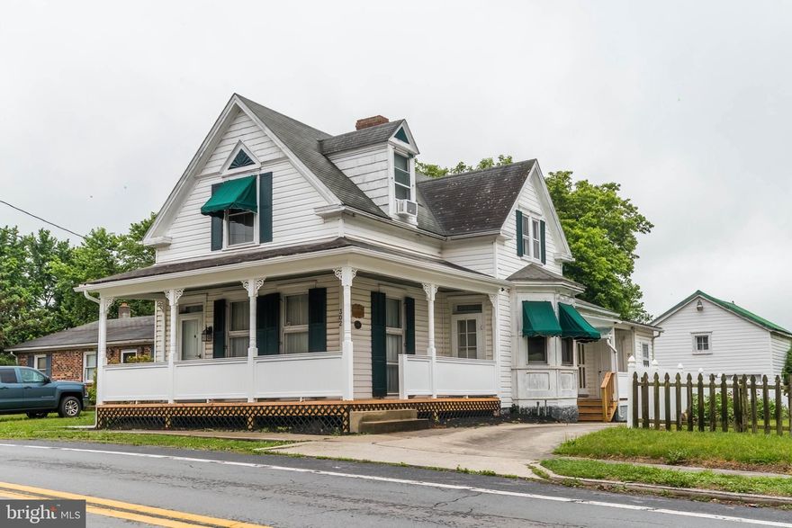 Well preserved historical home in the heart of Hedgesville. This timeless home features a spacious main level with open kitchen, family room with vaulted ceiling and relaxing views, formal dining room, living room and office/guest bedroom. Access wraparound porch from several rooms on the main level. Full bathroom on main level is convenient for guests. Laundry room tucked away off the side porch. Upper level features 2 bedrooms and full bath with skylight. Private driveway leads to detached garage with upstairs loft area. Private back deck, patio and fenced yard are a bonus. New porch.
