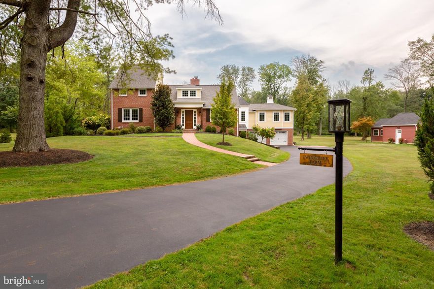 Welcome to Twin Creek Farm! Nestled in an idyllic setting, this stunning property offers a perfect blend of modern convenience and farmhouse charm. Reclaimed wood floors, exposed brick walls, and reclaimed barn beams all contribute to the unique character of this home. Thoughtful renovations and expansions include a main floor primary suite, a main floor guest/in-law suite with a private entrance, and a separate studio with heat, electric and water. Set at the end of a lane on a private and level 4.7 acre lot with a meandering stream, you will enjoy a serene lifestyle with the opportunity for owning horses or other animals. The main foyer is inviting and spacious. Stunning views and sunlight grace the living room, which could also be used as an office, while the large fireside dining room will invite you to enjoy this warm home with family and friends. The heart of the home is the sophisticated great room with a unique vaulted star ceiling, brick fireplace, and three glass-paned doors leading to the bluestone patio. This stunning space is fully open to the farmhouse-style chef’s kitchen which features custom pine cabinetry, Carrera marble countertops, and a large center island with bar seating. The primary bedroom suite on the main floor opens to a terrace, providing a peaceful outdoor escape. There is also a sitting area, walk-in closet, and en suite bathroom with a soaking tub under a large window, spa shower, and two vanities. Completing the main level is a separate guest/in-law suite with its own private entrance and patio, living area with kitchenette, two bedrooms and a full bathroom. This guest/in-law suite is also accessible from the main foyer of the home. Heading upstairs, you'll find two spacious bedrooms, a custom bathroom with a beadboard ceiling, and a comfortable sitting area that's a perfect reading nook or buddy study space. 
On the finished lower level, the property features a recreation room, mudroom, laundry room, wine cellar, pantry, storage room and access to the attached four-car garage. The outside spaces of this property are a true haven. A bluestone patio with doors from the kitchen area offers a perfect spot to savor the scenery. Enjoy expansive views from the primary suite's private terrace, creating a retreat within a retreat. The property also includes a four-car attached garage, a separate studio with heat, electric and water, and a whole house generator for added convenience. Conveniently located near Kimberton Whole Foods, The Buttery, Alba restaurant, General Warren Inn and a nearby park, this property combines convenience with the beauty of nature. Don't miss your chance to experience the perfect blend of modern comfort and rustic charm in this meticulously maintained farmhouse-style home.