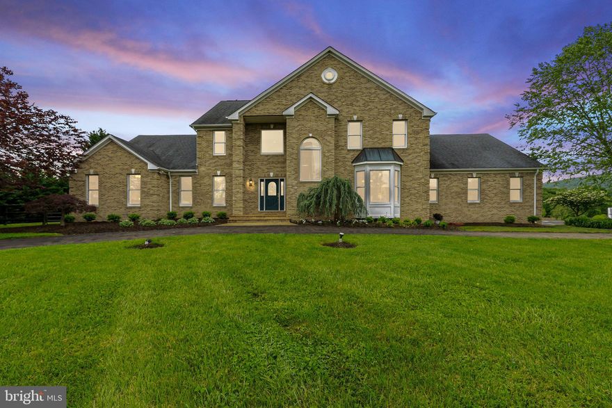 NEW PRICE!!!! Welcome to 18465 Yellow Schoolhouse Rd., Round Hill, VA 20141, where luxury and equestrian living harmonize on 10 acres of picturesque landscape. This captivating property, built in 1997, boasts a spacious Single Family Detached Home with 5 Bedrooms and 4.5 Bathrooms that offers an oasis of comfort and style. With approximately 7,014 Finished Sq Ft., there is plenty room for every pursuit and passion.

Step inside to discover a meticulously designed interior featuring 5 bedrooms, including a Main Level Primary Bedroom with Ensuite, ensuring privacy and convenience. With 4.5 full baths, every member of the household enjoys ample space for relaxation and rejuvenation.

Prepare to be enchanted by the fully renovated large gourmet kitchen, a culinary haven, complete with two stunning islands, perfect for hosting gatherings or savoring quiet moments. Natural light floods the home, enhancing the ambiance of the formal living and dining rooms, creating inviting spaces for entertaining guests or simply unwinding. Additional features include a new gourmet kitchen with stainless steel appliances, Crown Molding, and a Double-Sided Propane Gas Fireplace between the Kitchen and Family Room. A soaring 2-Story Ceiling and 3 Season Covered and Enclosed Porch add to the allure of this remarkable property.

The heart of the home, the soaring 2-story family room, beckons with warmth and elegance, while a large office and mudroom offer practicality and organization. Step outside to the rear deck, ideal for dining or enjoying panoramic views of the lush surroundings.

Venture downstairs to the Finished Basement, where a large recreation room, exercise room, and lower-level bedroom await. A second kitchen and walkout to the inground swimming pool ensure effortless entertainment and relaxation.

For equine enthusiasts, this property is a dream come true. A 4 Stall Renovated Barn, Run-in Sheds, paddocks, and a pond cater to every equestrian need. The property is fully fenced with 3 board fencing, providing safety and security to the property.

Car enthusiasts will delight in the oversized 3 Car Garage, providing ample storage and convenience. 

Escape the hustle and bustle of city life and embrace the peaceful serenity of country living at 18465 Yellow Schoolhouse Rd. With its breathtaking views and unparalleled amenities, this property offers a lifestyle of luxury and tranquility.