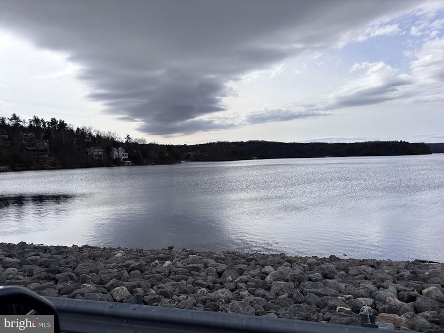 Nestled in a serene corner of Lake Holiday, this exceptional land parcel offers a unique opportunity to create your dream retreat. With its irregular shape and gentle sloping terrain, the lot presents a canvas for architectural creativity, allowing you to design a residence that harmonizes with the natural beauty surrounding it. Imagine waking up to breathtaking views of the tranquil lake, where shimmering waters reflect the changing hues of the sky. The property boasts direct access to a variety of water-oriented activities, including powered boating, canoeing, kayaking, and fishing, ensuring that every day can be an adventure. The community features two docks, providing convenient access to the lake for leisurely afternoons spent on the water or peaceful evenings watching the sunset. This exclusive location is not just about the views; it's about the lifestyle. The community offers a wealth of amenities designed for recreation and relaxation. Enjoy the luxury of a private beach, perfect for sun-soaked days, or take advantage of the extensive network of bike trails and jogging paths that wind through the picturesque landscape. For those who appreciate sports, the community features basketball courts, tennis courts, and pickleball courts, catering to both competitive spirits and casual players alike. The clubhouse and recreational center serve as social hubs, where neighbors become friends and memories are made. With a fitness center and health club on-site, maintaining an active lifestyle is effortless. Safety and convenience are paramount, with a security gate ensuring peace of mind and common area maintenance included in the association fee. Snow removal services further enhance the ease of living in this idyllic setting. This land is more than just a property; it's an invitation to embrace a lifestyle of luxury, leisure, and connection with nature. Whether you envision a cozy lakeside cottage or a grand estate, this lot offers the perfect backdrop for your aspirations. Experience the tranquility of lake living while enjoying the vibrant community amenities that make this location truly special. Your dream home awaits in this exclusive lakeside haven.